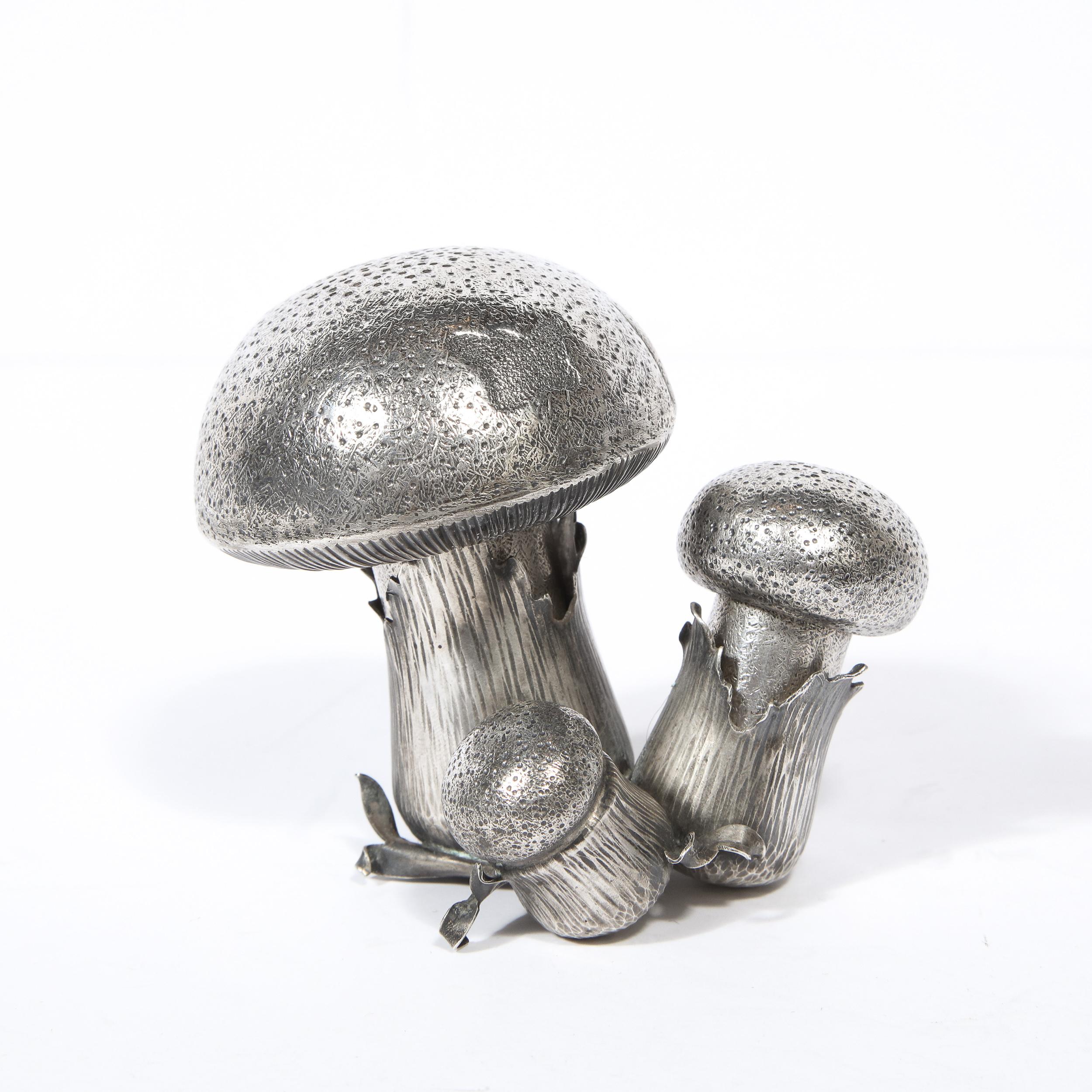 This elegant modernist salt shaker and pepper shaker were handcrafted and signed by Buccellati in Italy. The set features a cluster of three trumpet mushroom. The larger one represents the pepper shaker , while the medium sized one represents the