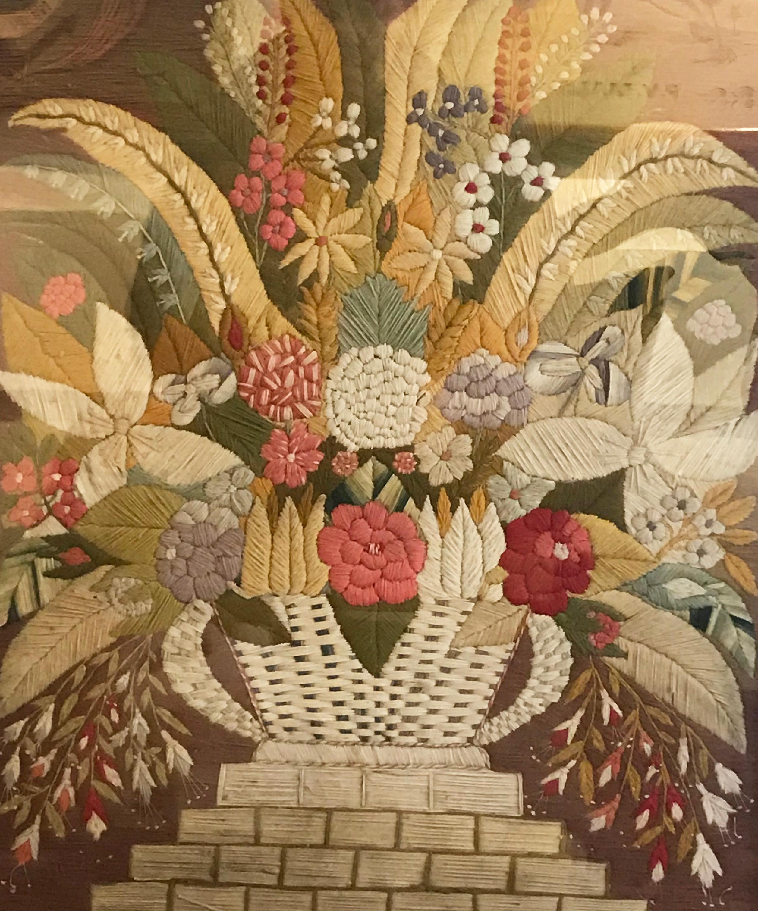 Woolwork picture of a floral still-life depicting
a plethora of multicolored flowers and leaves in
a basket sitting atop a stepped base.
Mounted in its original bird's-eye maple frame
English, circa 1875.



   