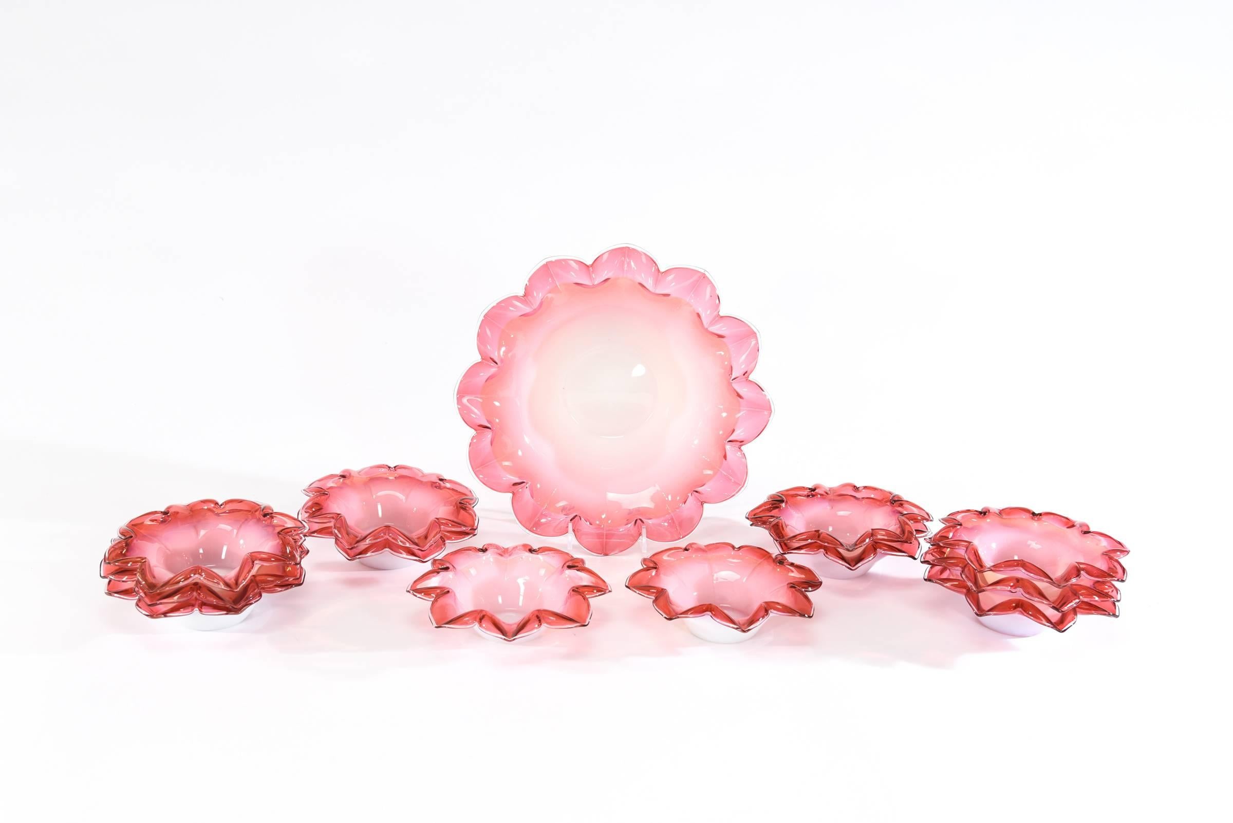 This is one set that you might not see again and it includes the large and practical serving bowl and 12 matching dessert bowls. The hand blown petal shaped bowls are cased in white with delicate shading from cranberry to pink to clear. Perfect for