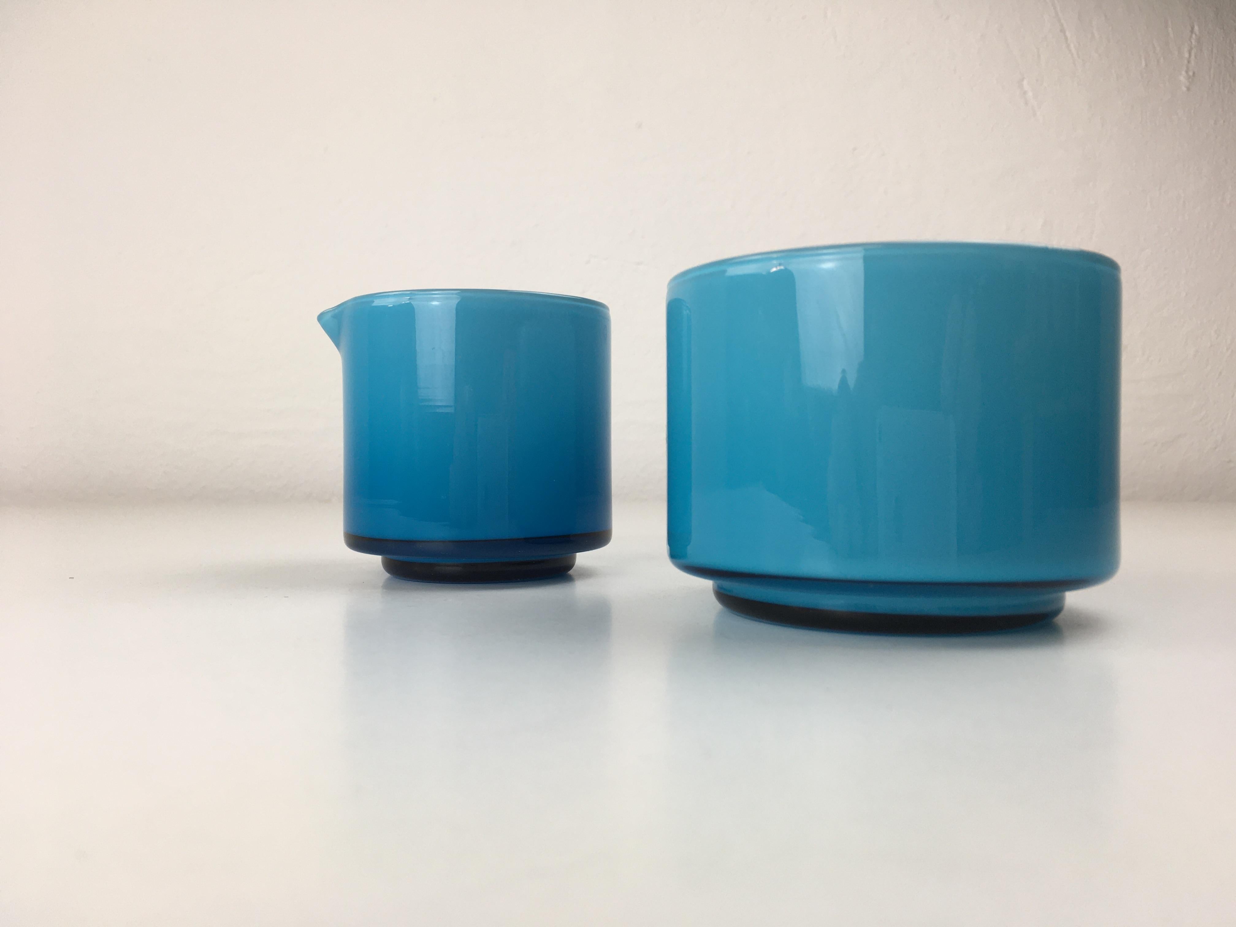 Set of turquoise-colored creamer and sugar bowls in handblown opaline glass, designed by Michael Bang and produced by Holmegaard in the 1970s.

The well designed set with it´s 1970´s colors is in very good condition.

Michael Bang (1942-2013)