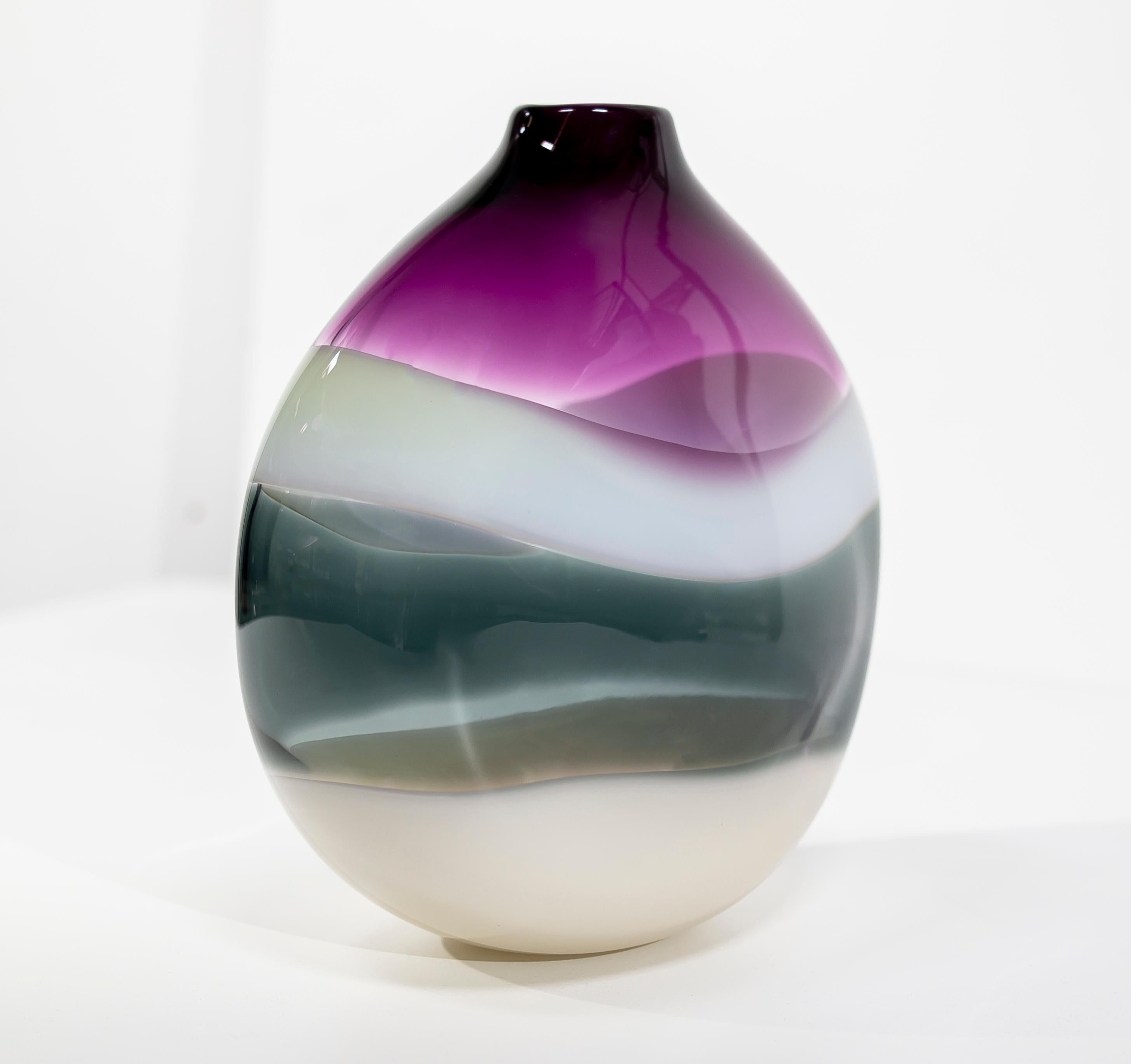 Handblown glass vase. Banded series: Inspired by the rich hues and topography of Southern California, alternating layers of opaque and transparent colors are applied to clear glass. New colors are formed by overlaps, adding depth to the pieces.