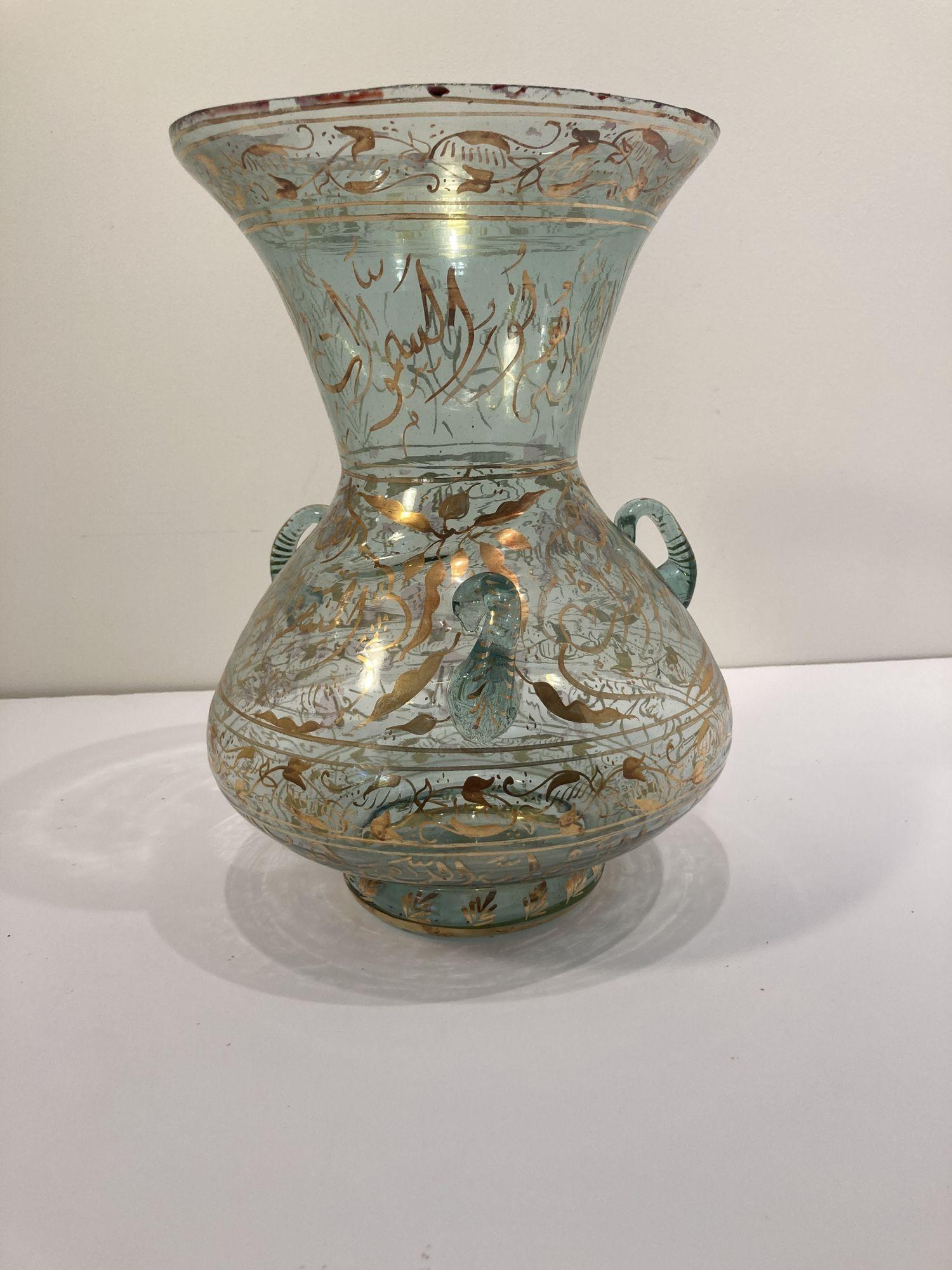 Handblown Mosque glass oil lamp in Mameluke style gilded with Arabic Calligraphy
Middle Eastern Mosque lamp in the Islamic tradition, Moorish style hand painted blown clear glass with gilded calligraphic inscriptions.
Dimensions: 14.5in. height x