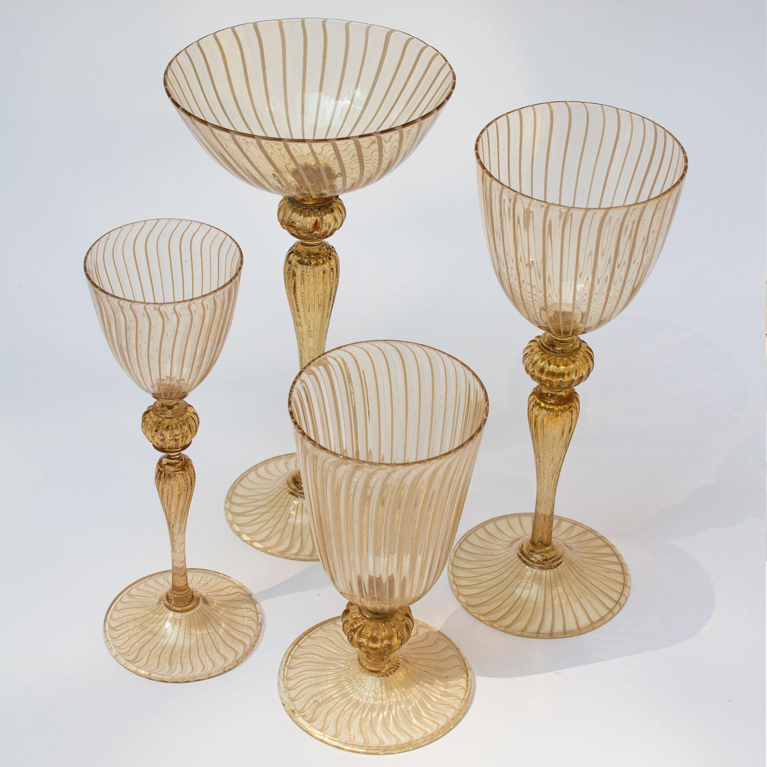 Handblown Lattice Murano stemware service for eight persons without a single chip. Featuring beautiful champagne goblets, red- and white wine goblets, aperitif glasses, plates and bowls creating a lovely table setting. The glass is lightly yellow