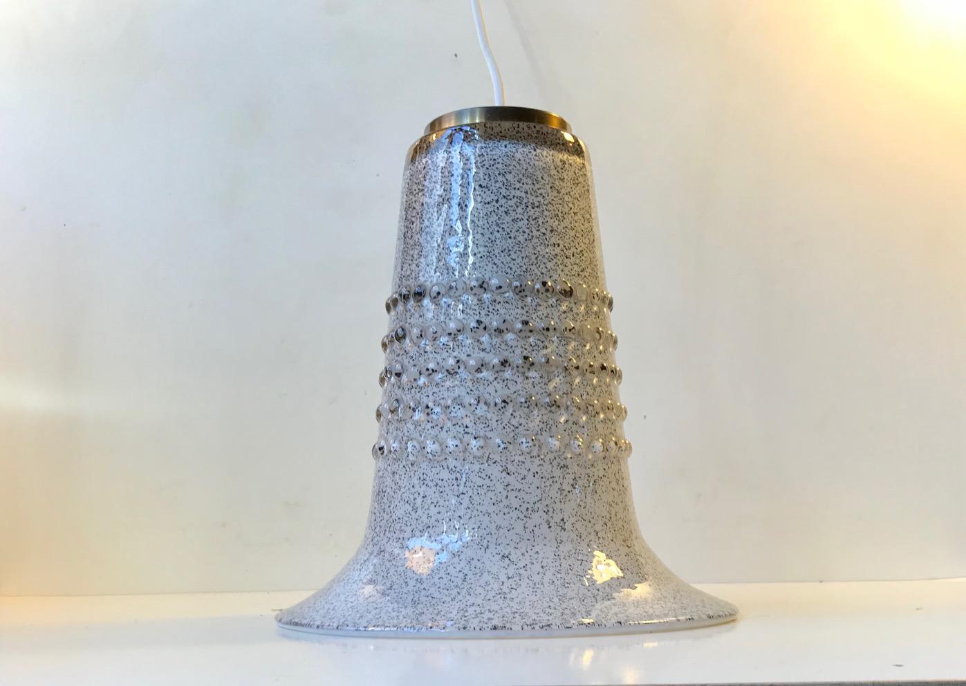 Unique hand blown and bell shaped ceiling lamp designed by Gert Nyström. It was created at Hyllinge Glass Studio in Sweden, circa 1970. It features a speckled black in white exterior with raised glass dots and an all white interior.
