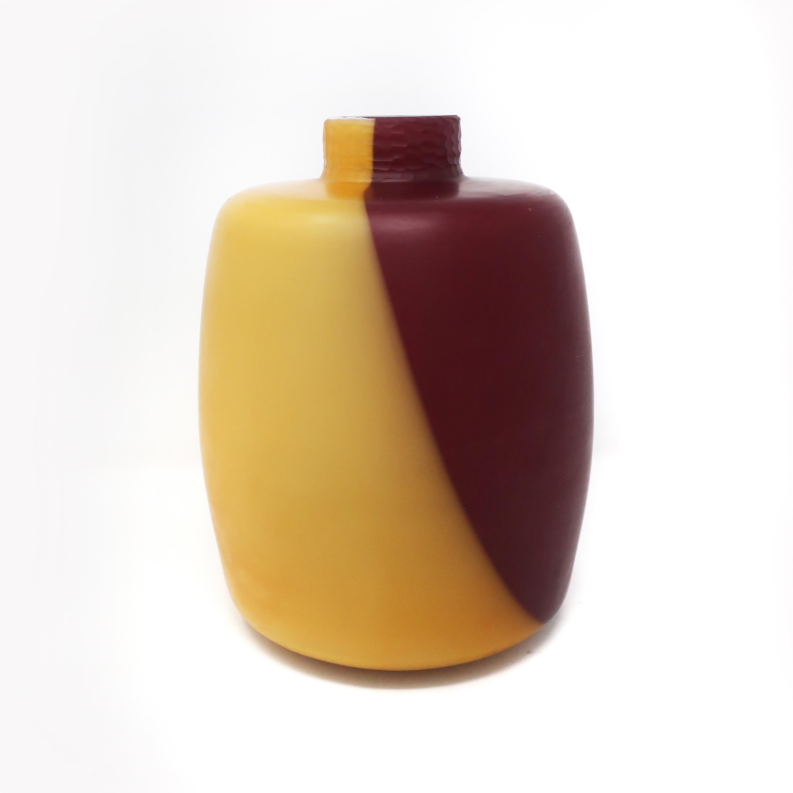 A stunning maroon and yellow/orange handblown glass vase designed by Ivan Baj for his company, Arcade. Since its inception in 1990 Arcade has produced limited edition Murano glass pieces. Each piece is free mouth blown and is therefore unique.