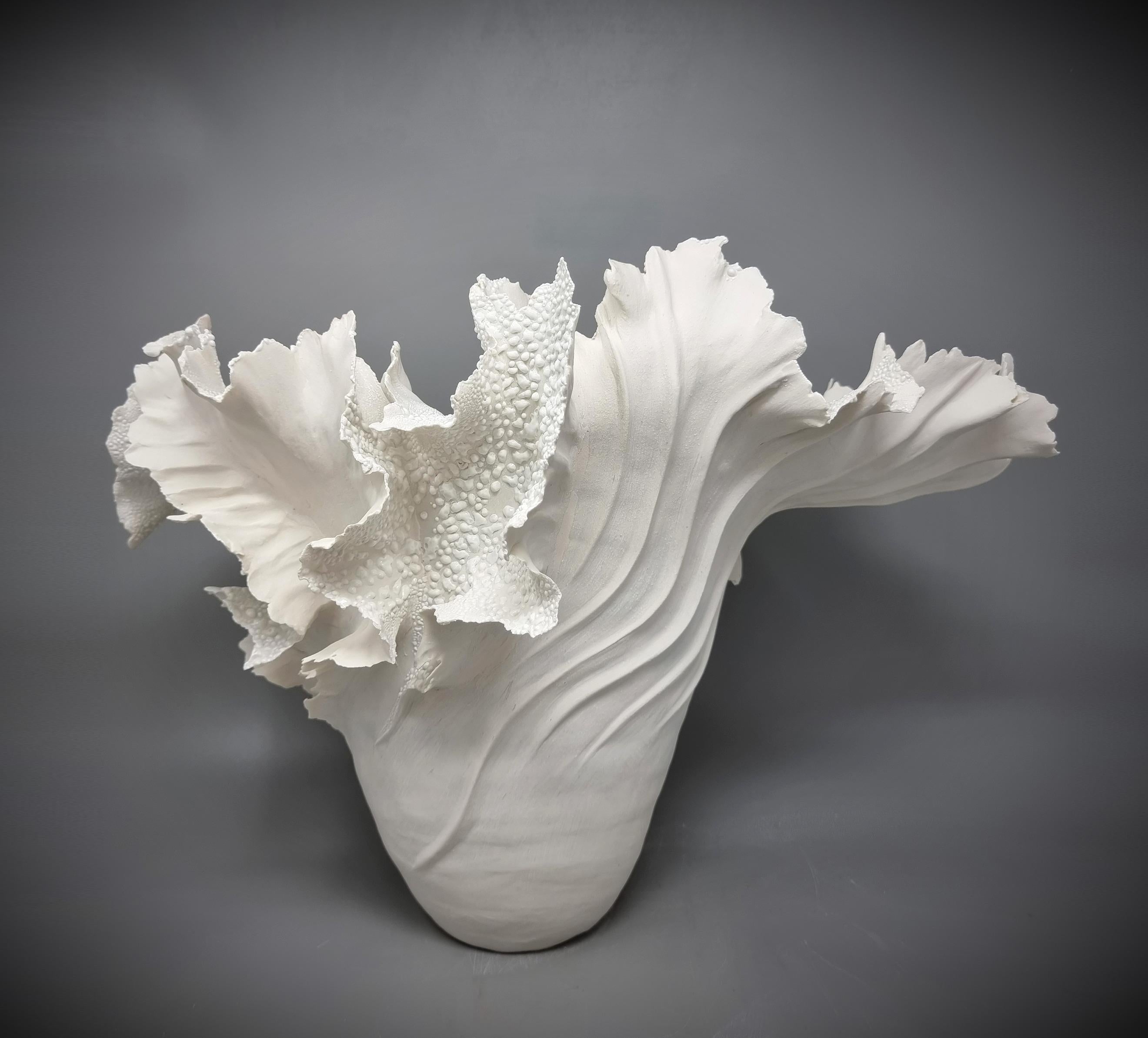 Handbuilt paperporcelain sculpture in shape of a vase. This is from the 