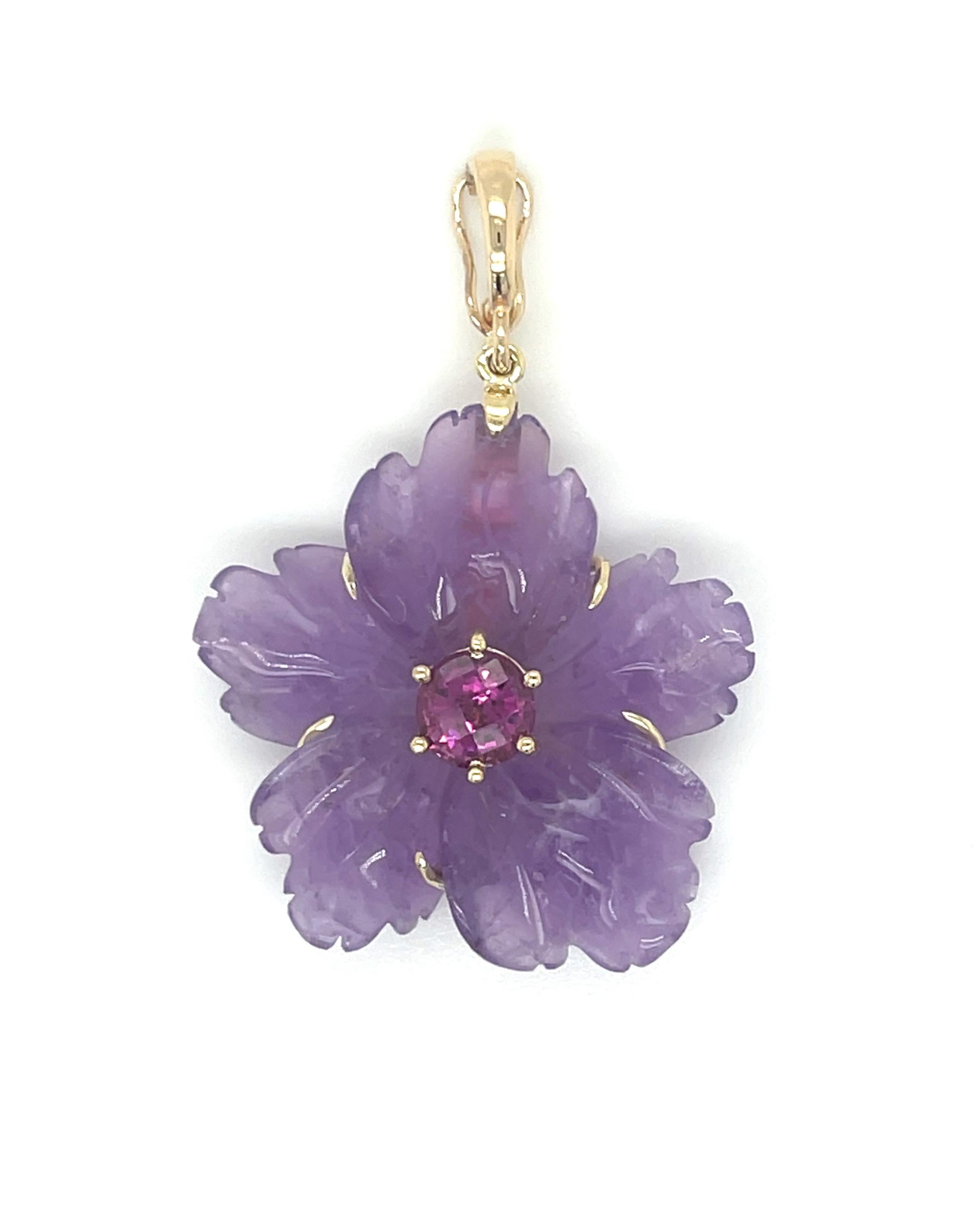 This eye-catching necklace features a gorgeous amethyst pendant set in 18k yellow gold on a strand of pearls and pink tourmaline beads. The flower pendant has been hand carved from a single amethyst crystal with lovely medium purple color. The