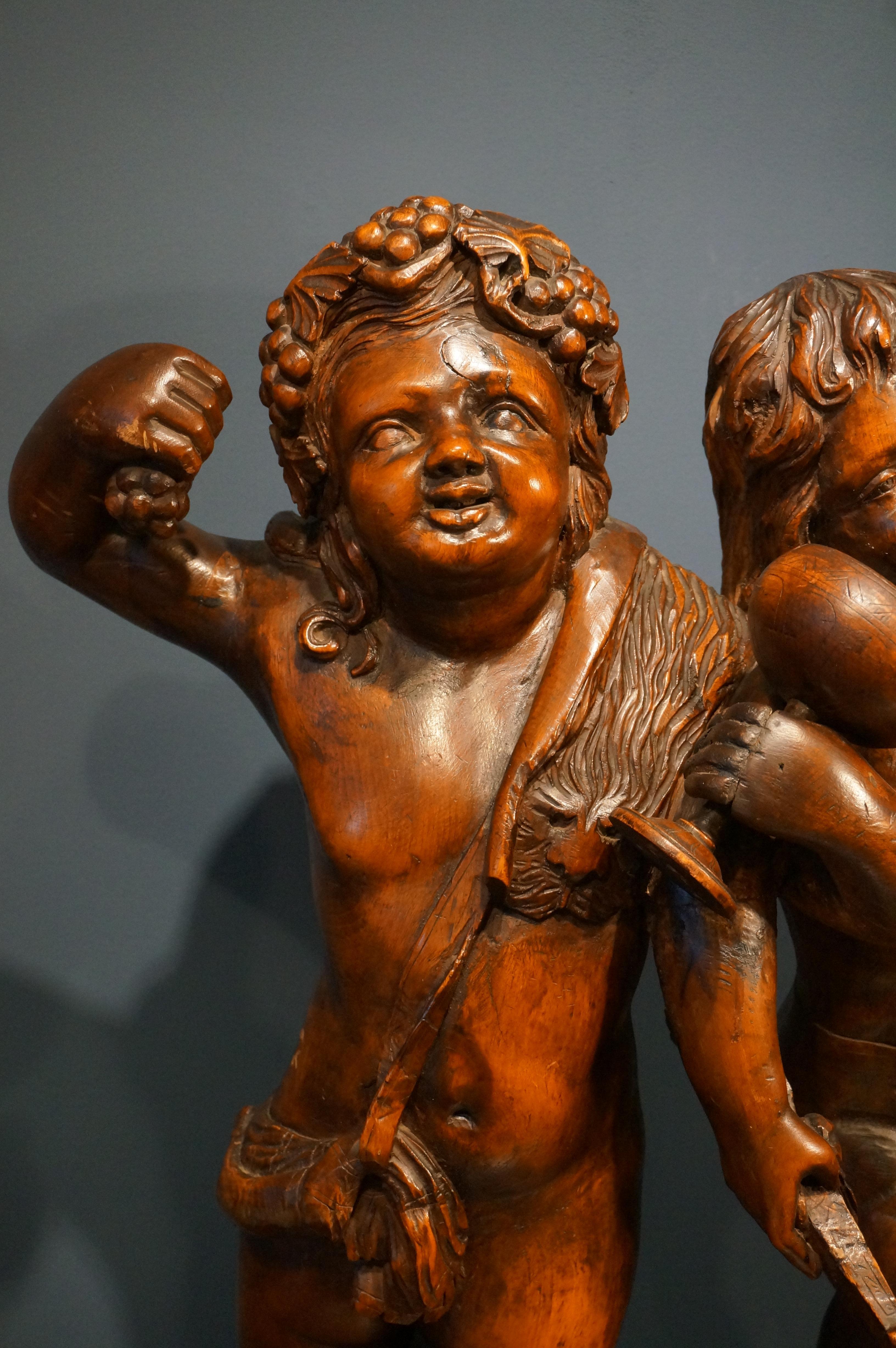 Baroque Handcarved baroque wooden sculpture depicting Bacchus and Amor, 18th century For Sale