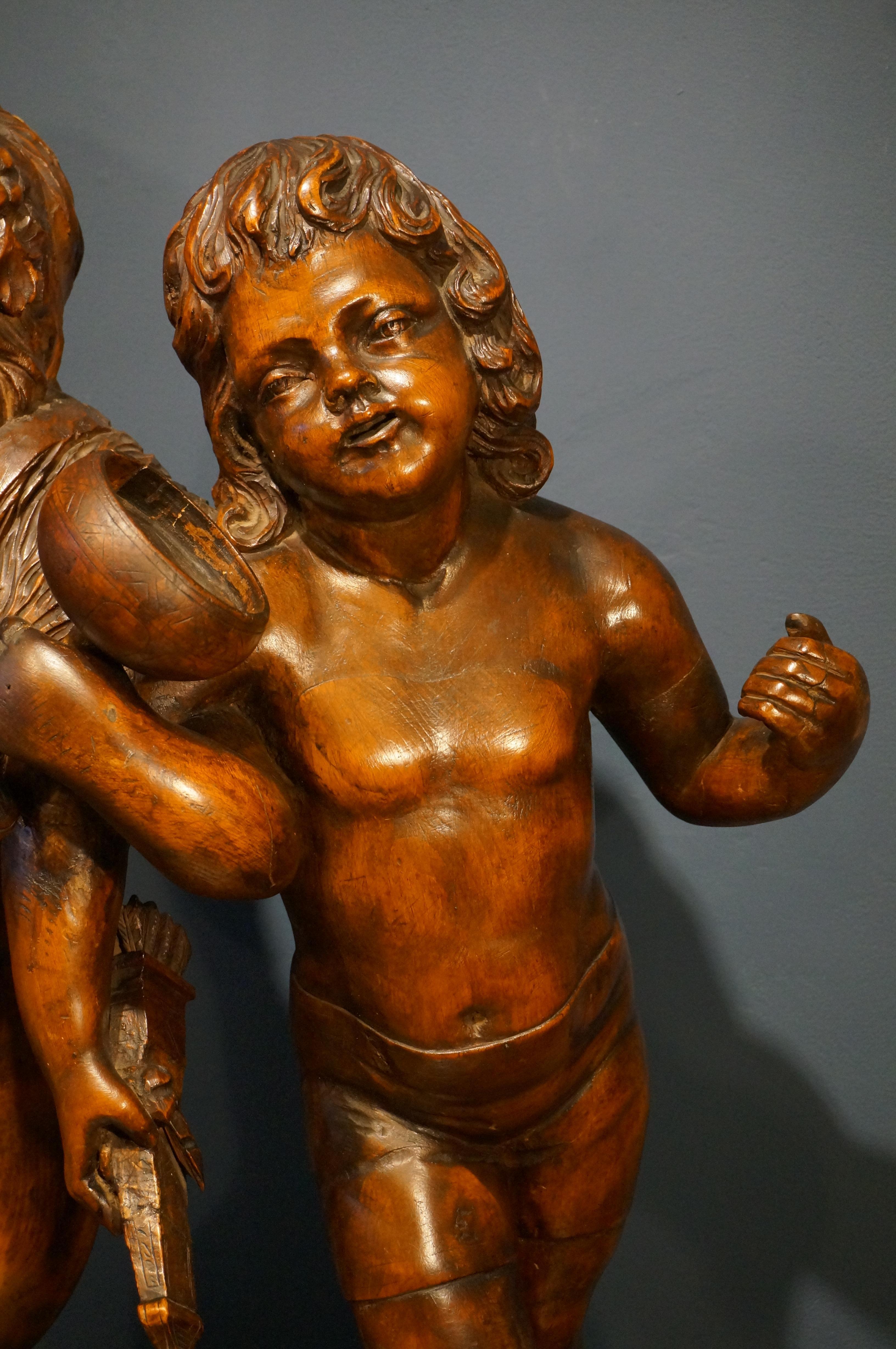 German Handcarved baroque wooden sculpture depicting Bacchus and Amor, 18th century For Sale