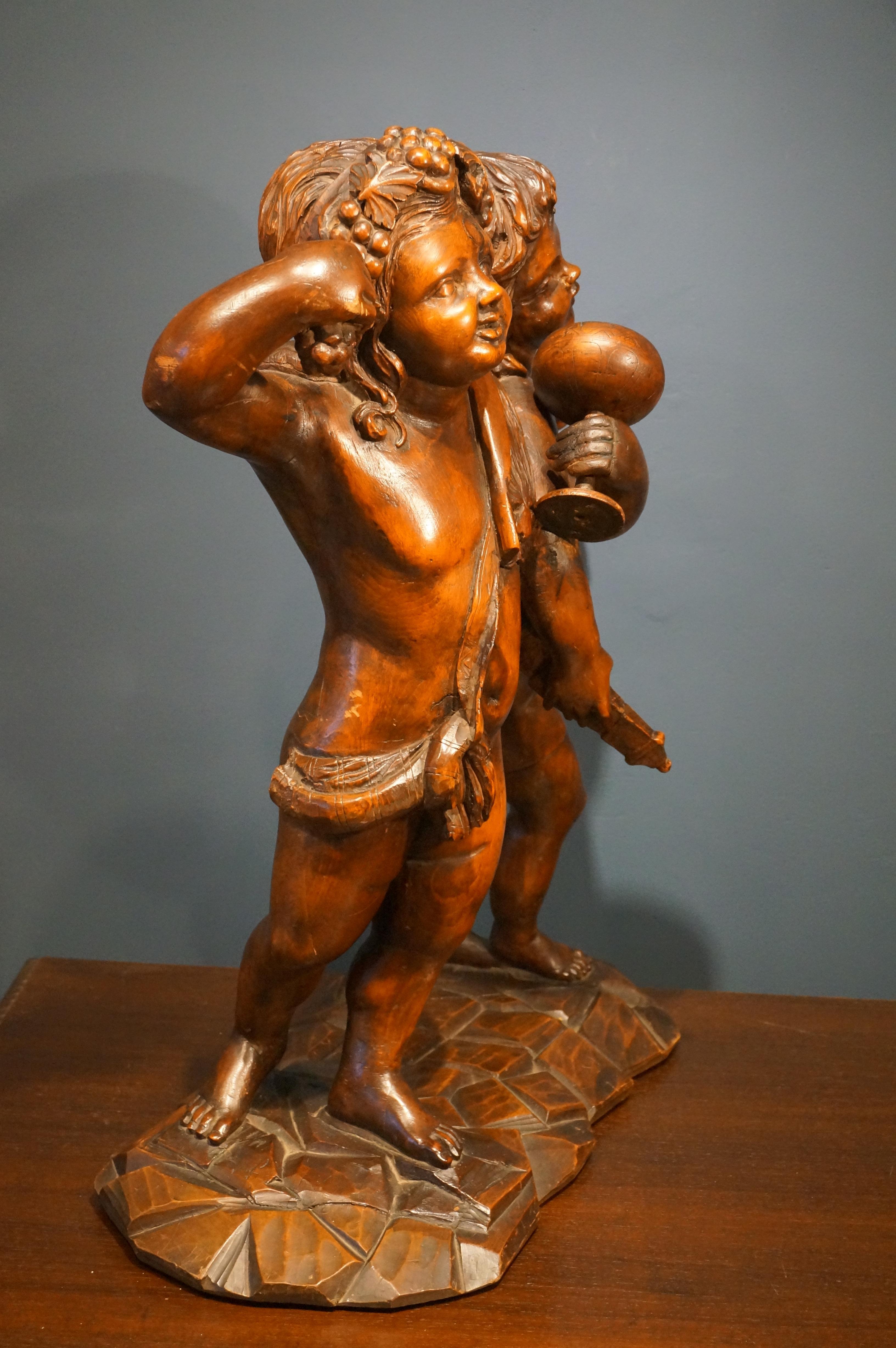 Wood Handcarved baroque wooden sculpture depicting Bacchus and Amor, 18th century For Sale