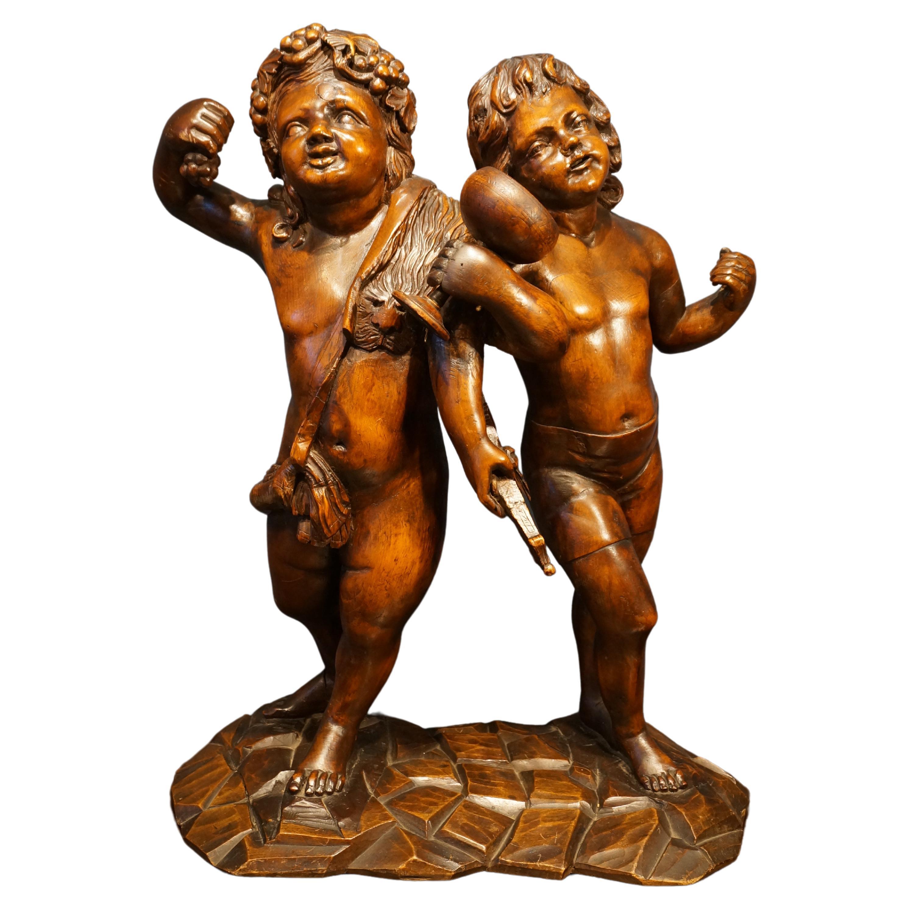 Handcarved baroque wooden sculpture depicting Bacchus and Amor, 18th century For Sale