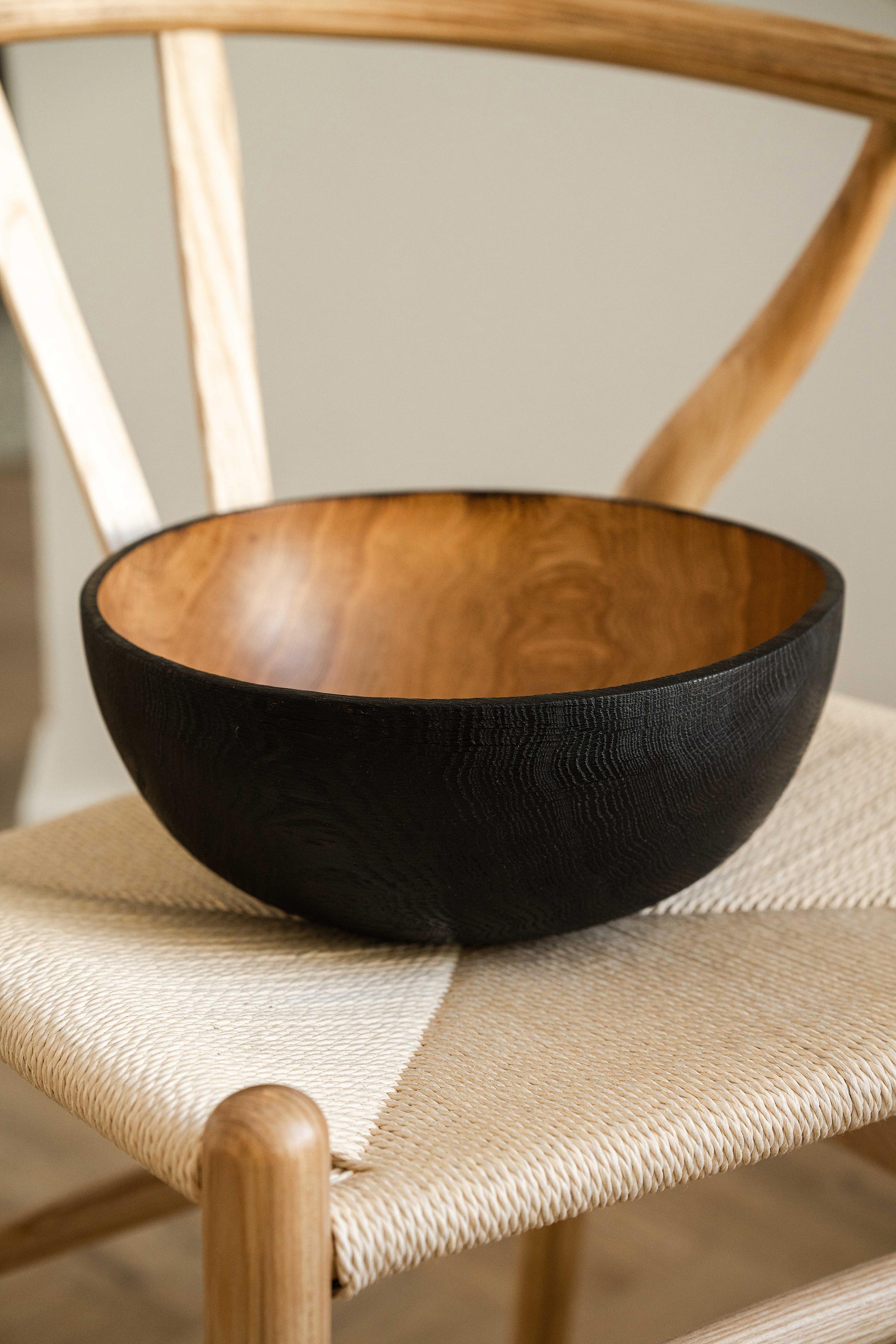 A large charred wood bowl will become a centerpiece on your table and a perfect vessel for all your fruits or vegetables in the kitchen. Hand-carved from one solid piece of wood charred on the outside to add this beautiful opaque black color and
