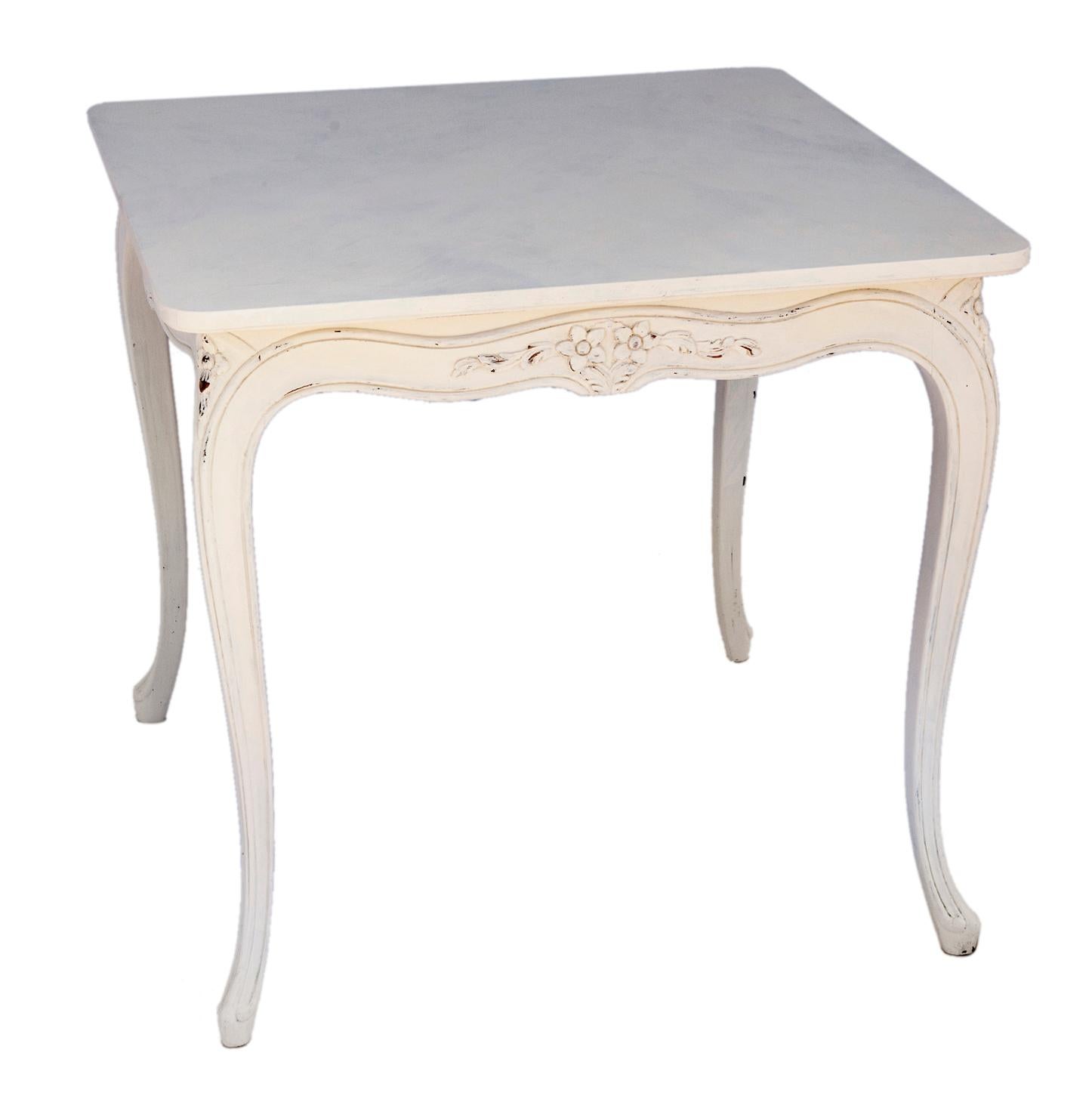 French provincial square card or game table in creamy white finish. Hand carved with decorative apron & carved cabriole legs. 

