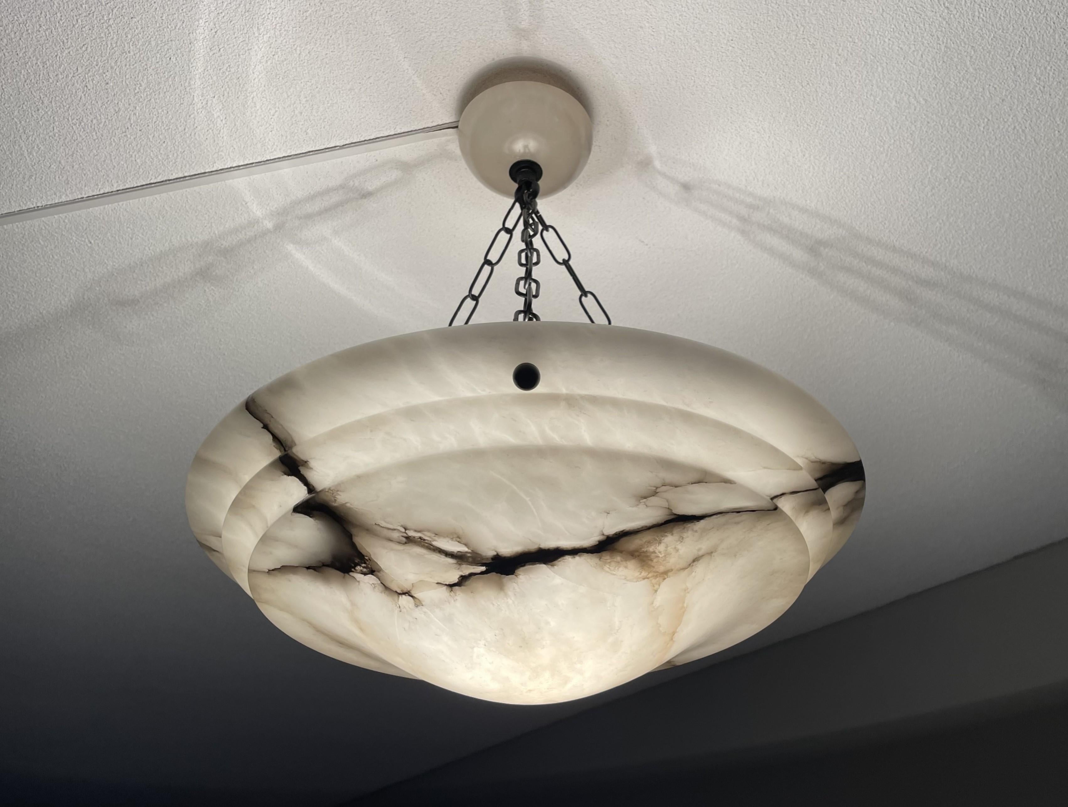 Stunning and large size, alabaster pendant of great design and top quality workmanship.

This rare fixture from the heydays of the European Art Deco era could soon be lighting up your days and evenings. Its remarkable, circular and layered shade