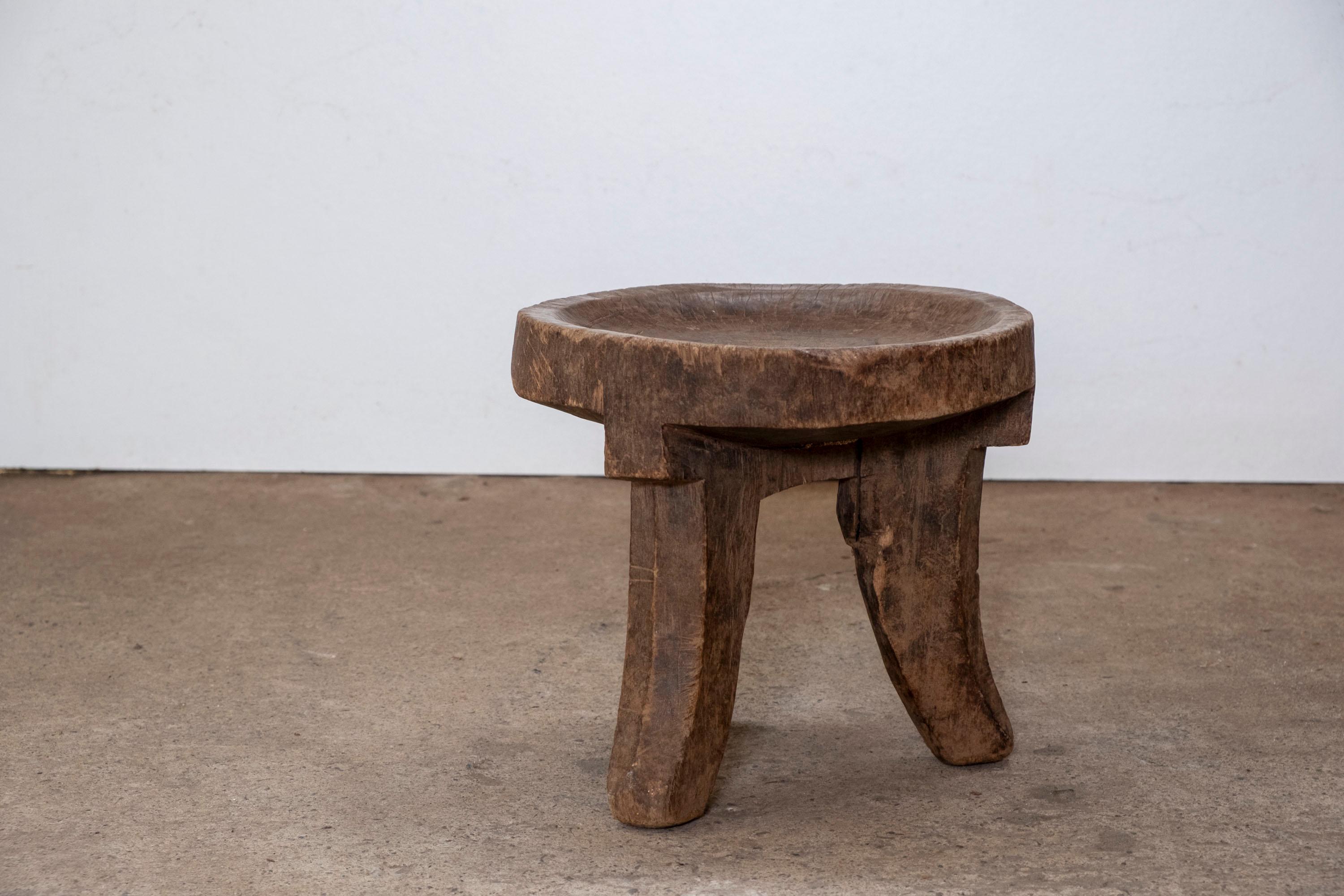 Sculptural side table or stool hand carved from a single piece of wood.