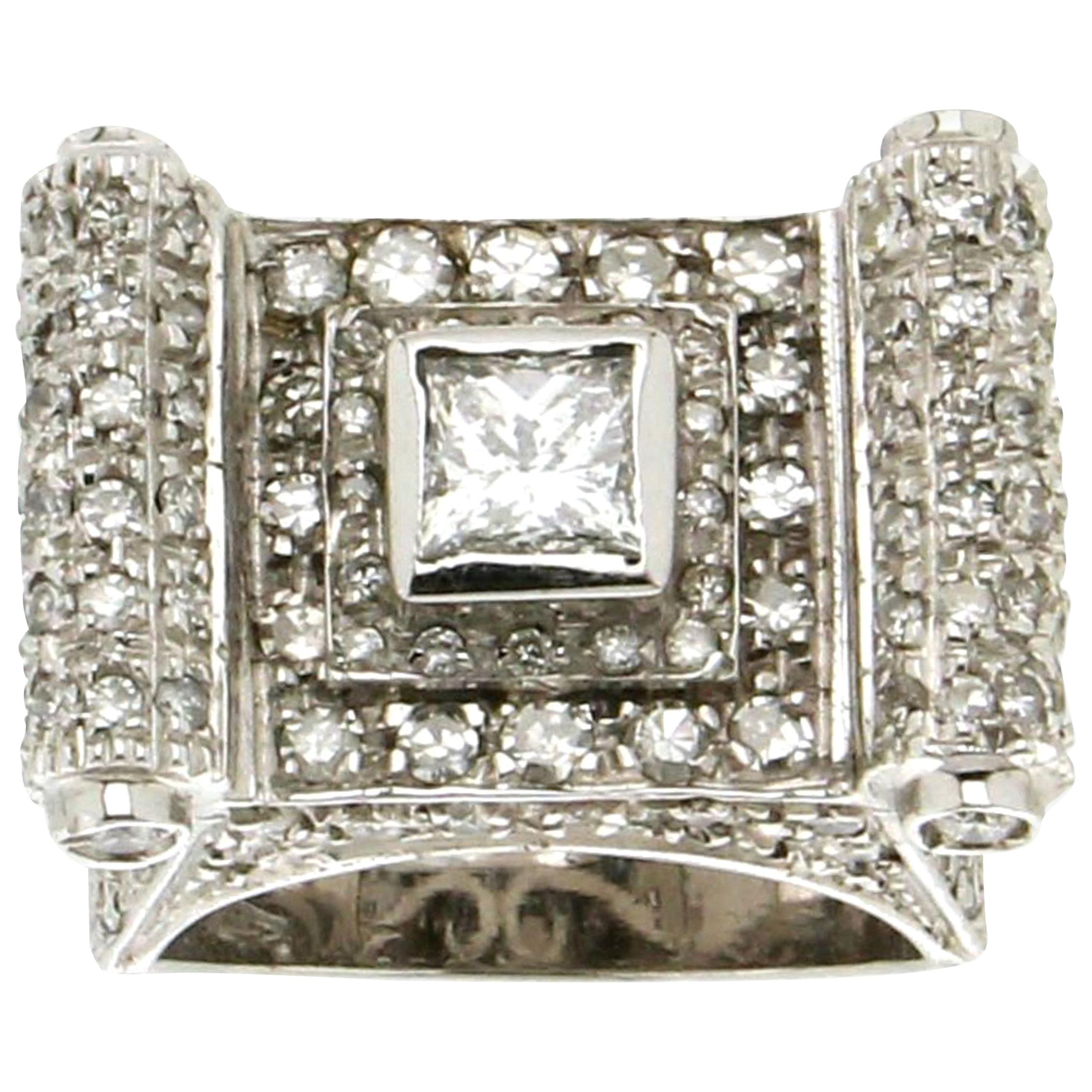 This exceptional ring is crafted in 18kt white gold, combining modern elegance with timeless sophistication. At its center is a stunning princess-cut diamond, weighing 0.63 carats, celebrated for its sleek, geometric lines and radiant brilliance.
