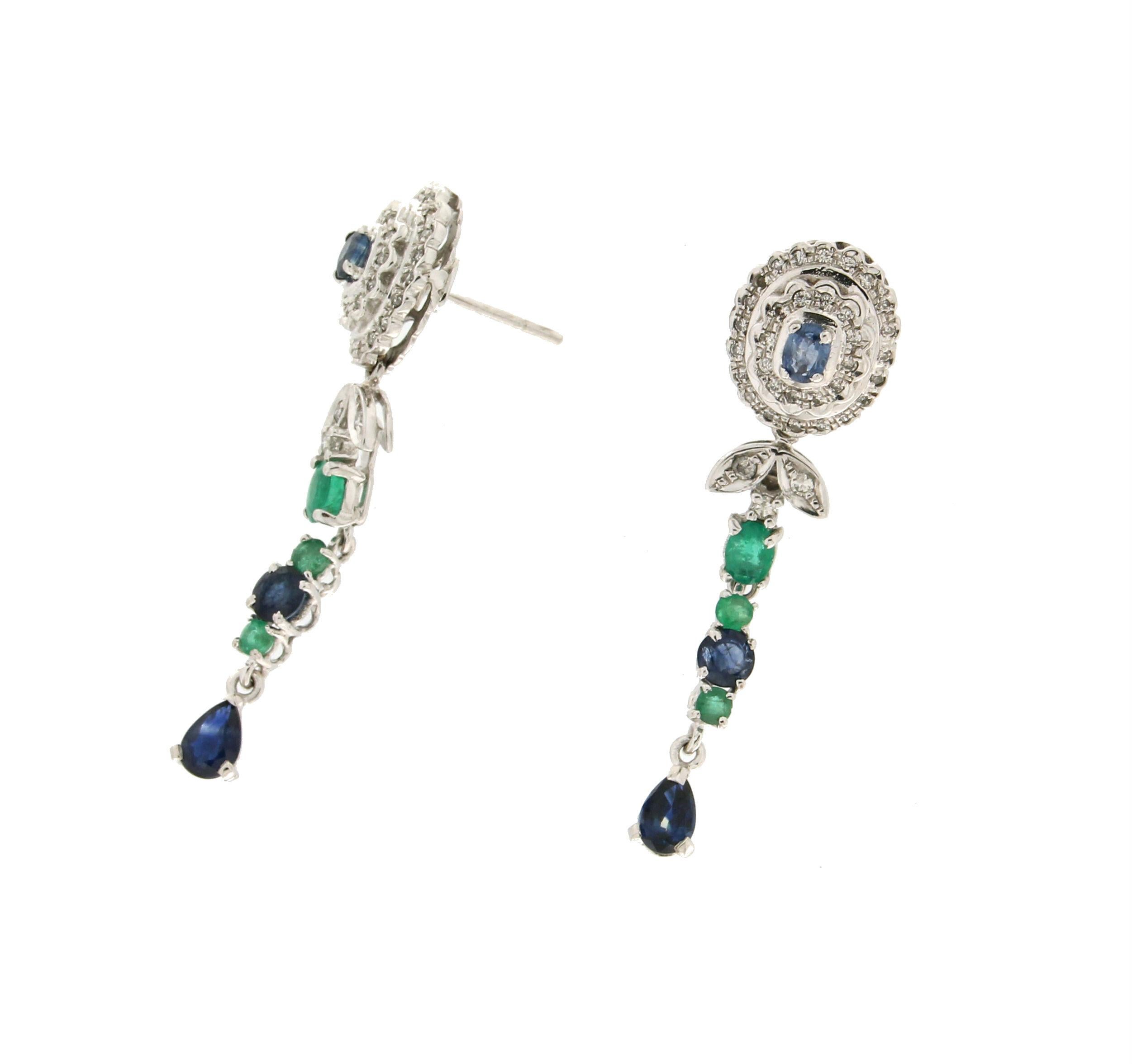 18 karat white gold drop earrings. Handmade by our artisans assembled with diamonds,sapphires and emeralds

Sapphires and emeralds total weight 0.90 karat
Diamonds weight 0.50 karat
Earrings total weight 8.40 grams