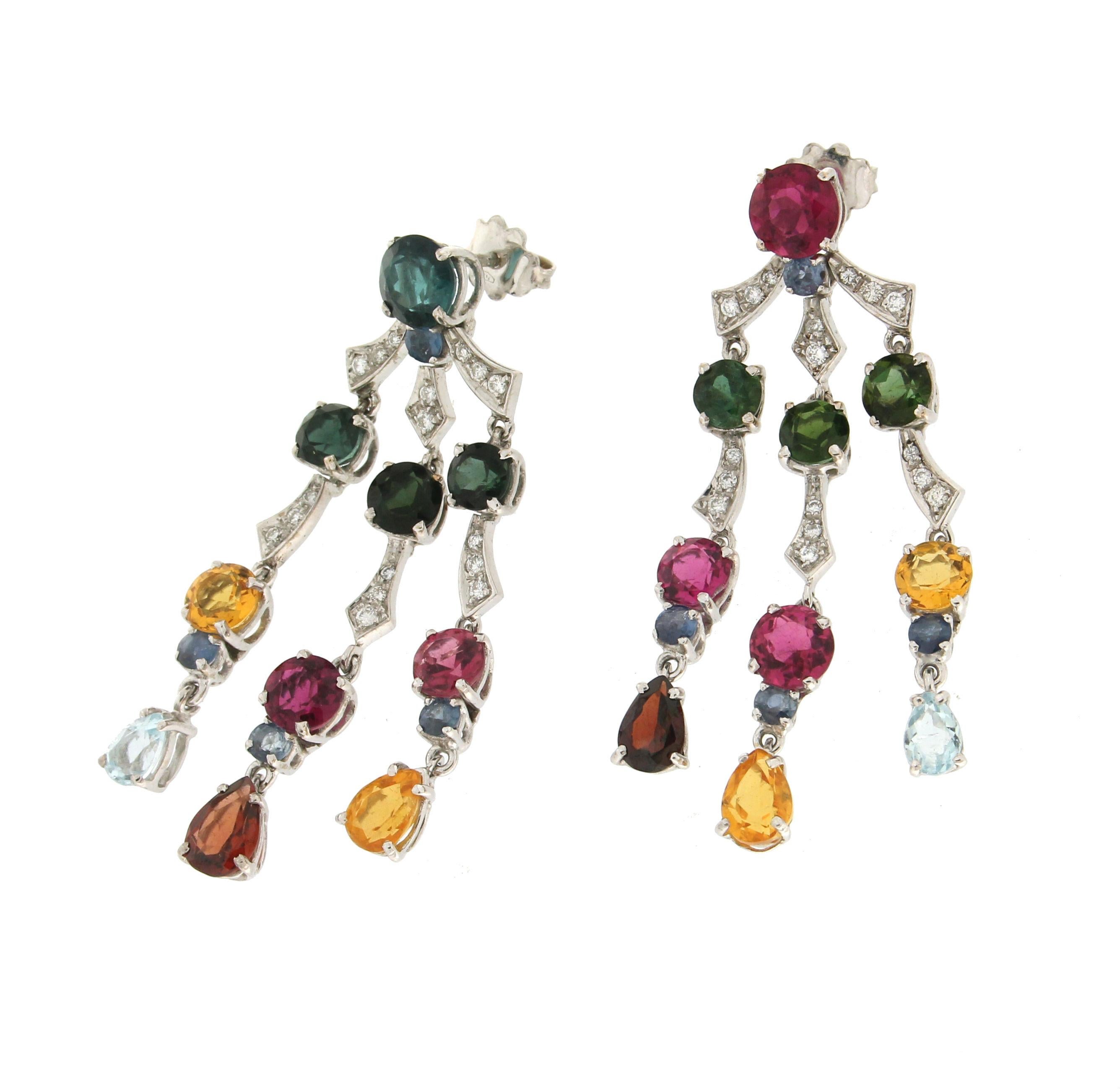 18 karat white gold drop earrings. Handmade by our artisans assembled with diamonds,blue sapphires,green blue and pink tourmaline, yellow citrine,garnet and aquamarine.

Tourmaline total weight 19.50 karat
Diamonds weight 0.45 karat
Sapphires weight
