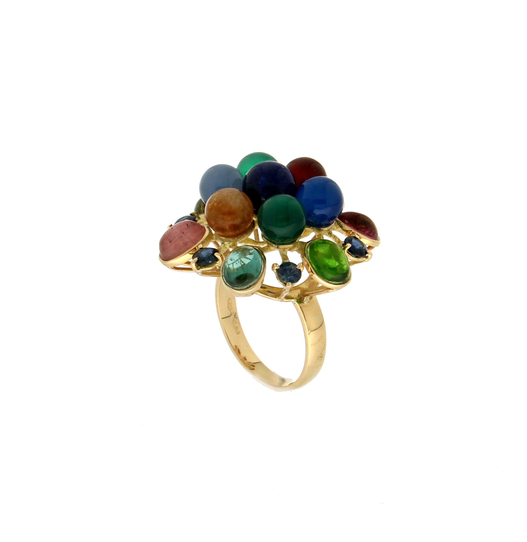 18 karat yellow gold cocktail ring. Handmade by our artisans assembled with sapphires and semiprecious stones

Sapphires weight 1.23 karat
Ring total weight 13.20 grams
Ring size 7.75 US 16 Ita
(all rings are can be resized)