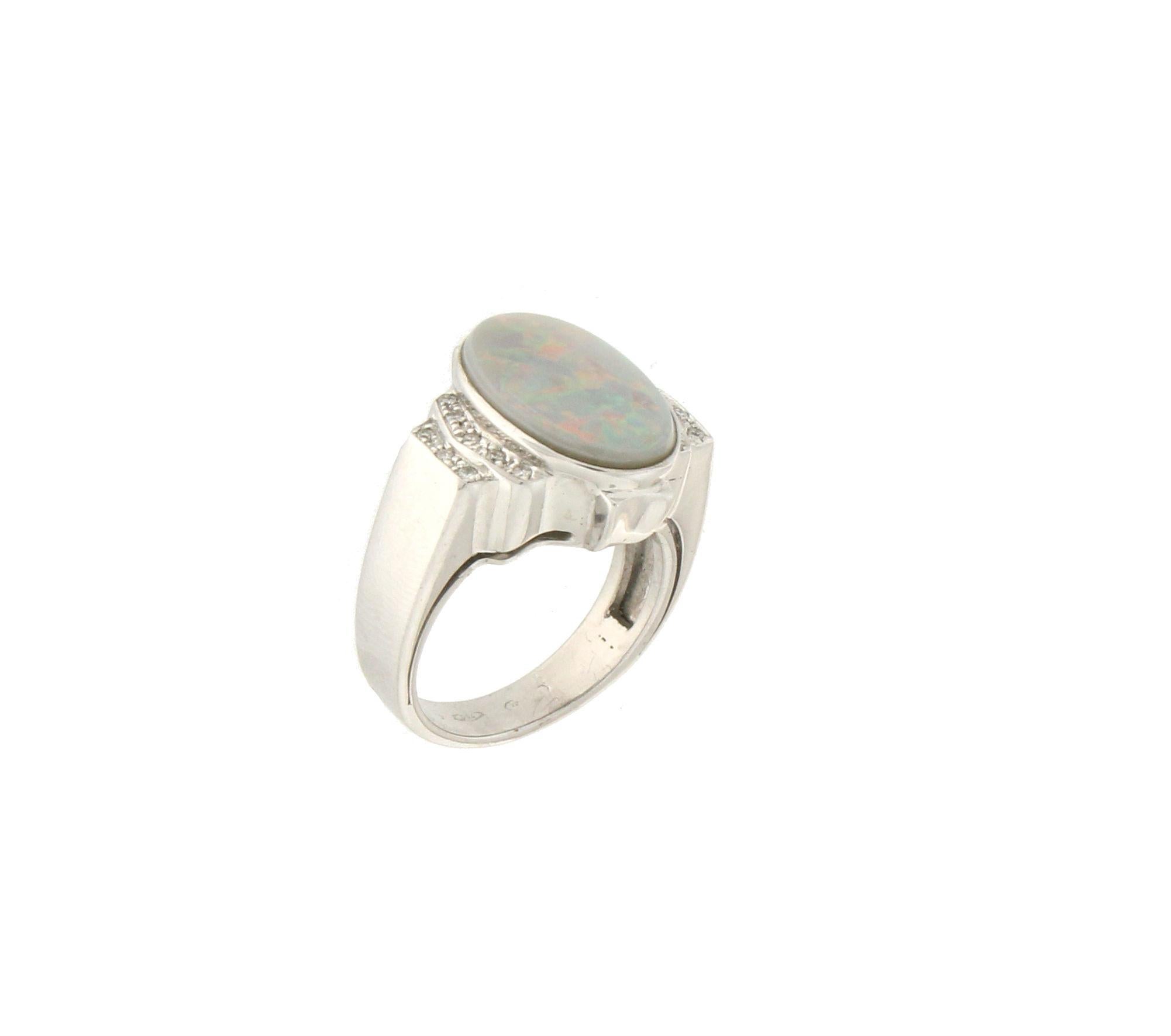 18 karat white gold cocktail ring. Handmade by our artisans assembled with diamonds and Australian opal

Diamonds weight 0.16 karat
Opal weight 3.80 karat
Ring total weight 11.30 grams
Ring size 6.85 US 13.50 Ita
(all rings are can be resized)