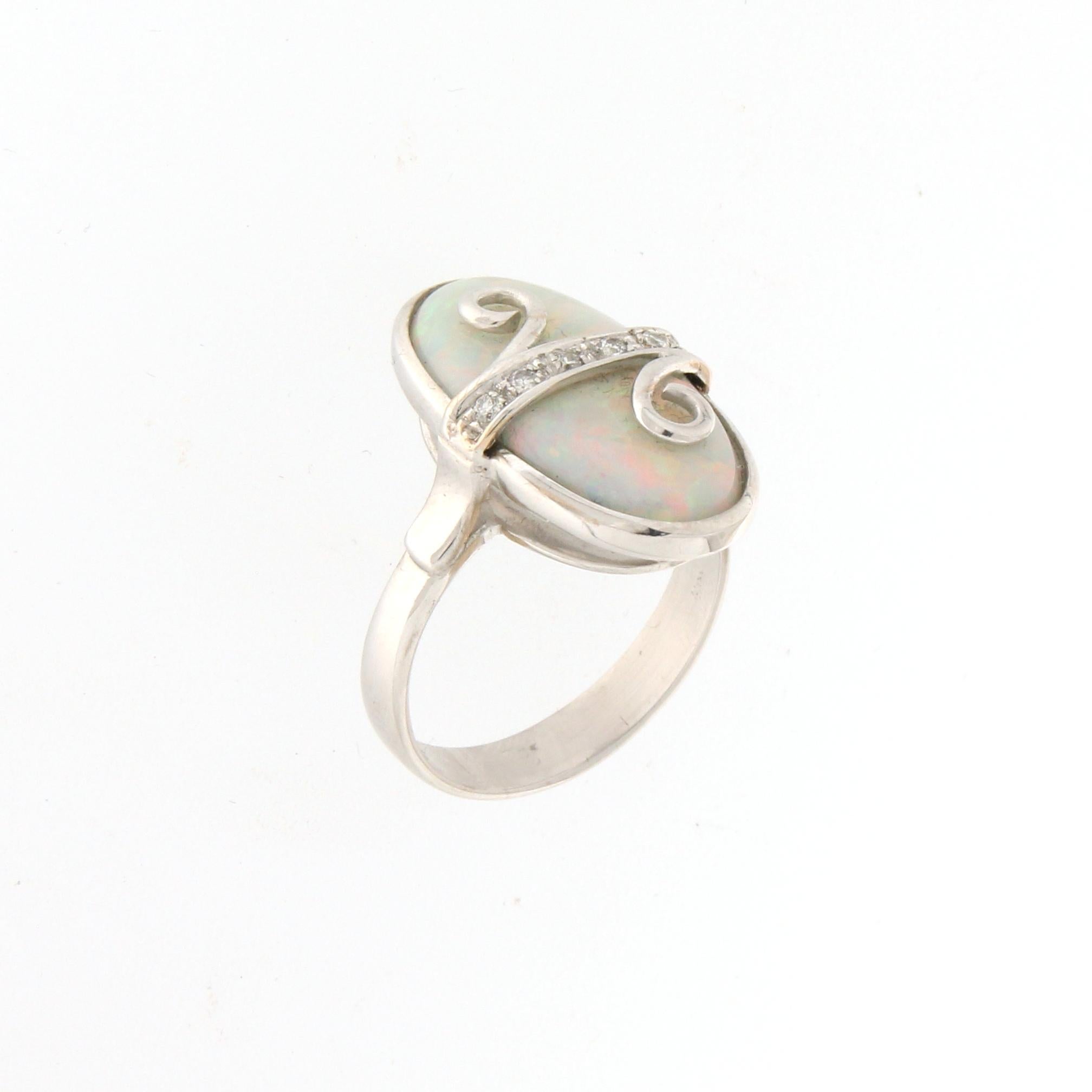 18 karat white gold cocktail ring. Handmade by our artisans assembled with diamonds and Australian opal

Diamonds weight 0.10 karat
Ring total weight 7.20 grams
Ring size 7.75 US 16.40 Ita
(all rings are can be resized)