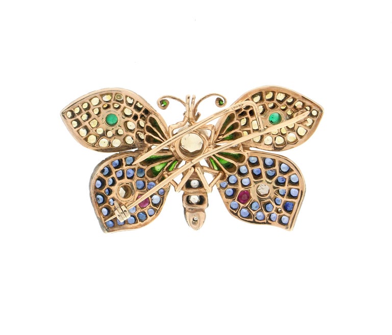 Butterfly 14 karat yellow gold and 800 thousandths silver brooch. Butterfly Handmade by our craftsmen assembled with old cut diamonds,blue and yellow sapphires,ruby,emeralds and green enamel.

Butterfly total Weight 25.50 grams
Ruby,emeralds and