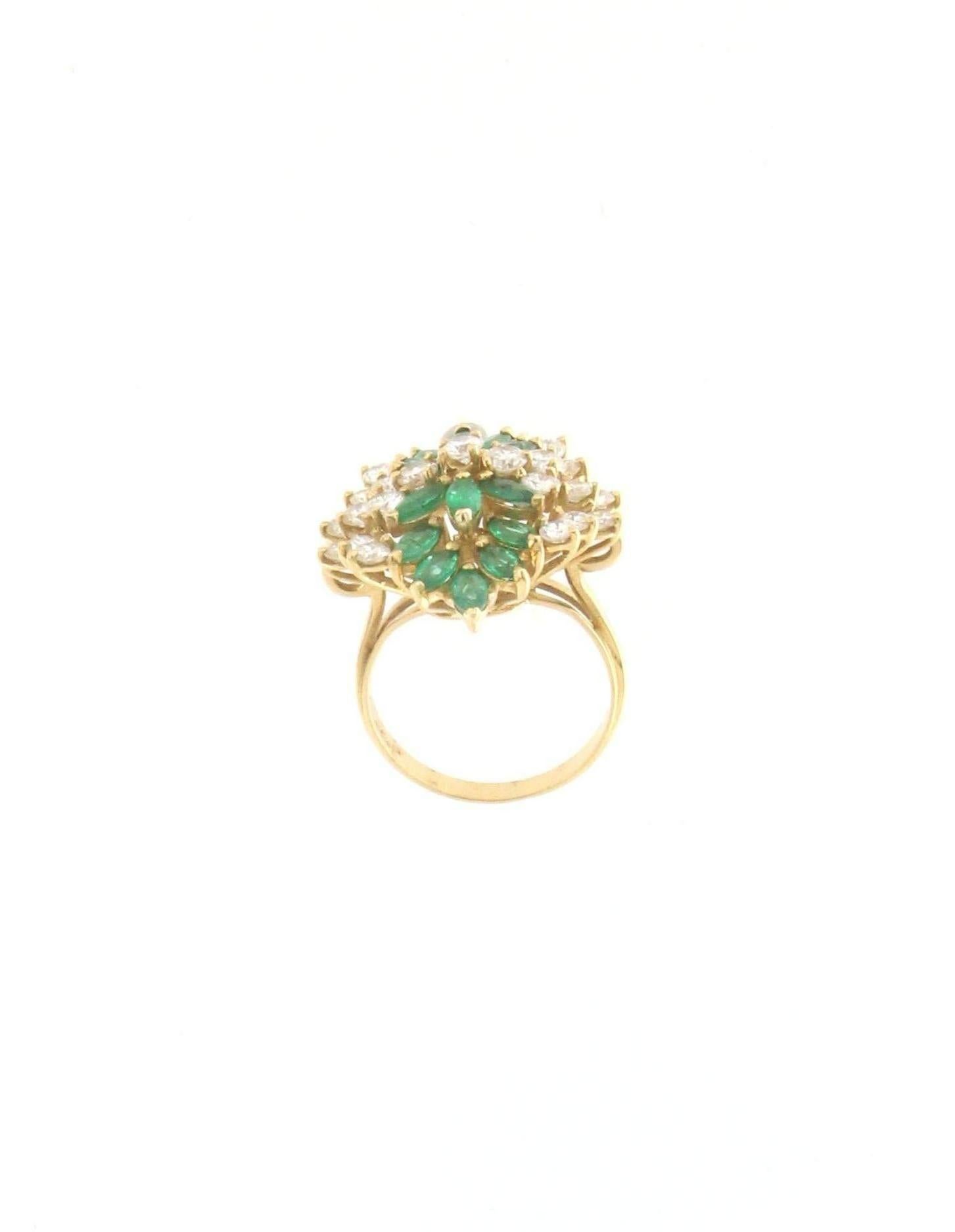 This magnificent 18K yellow gold cocktail ring is a true masterpiece of fine jewelry, featuring an exquisite combination of marquise-cut diamonds and marquise-cut emeralds. Its striking design, reminiscent of a floral or leaf motif, radiates luxury