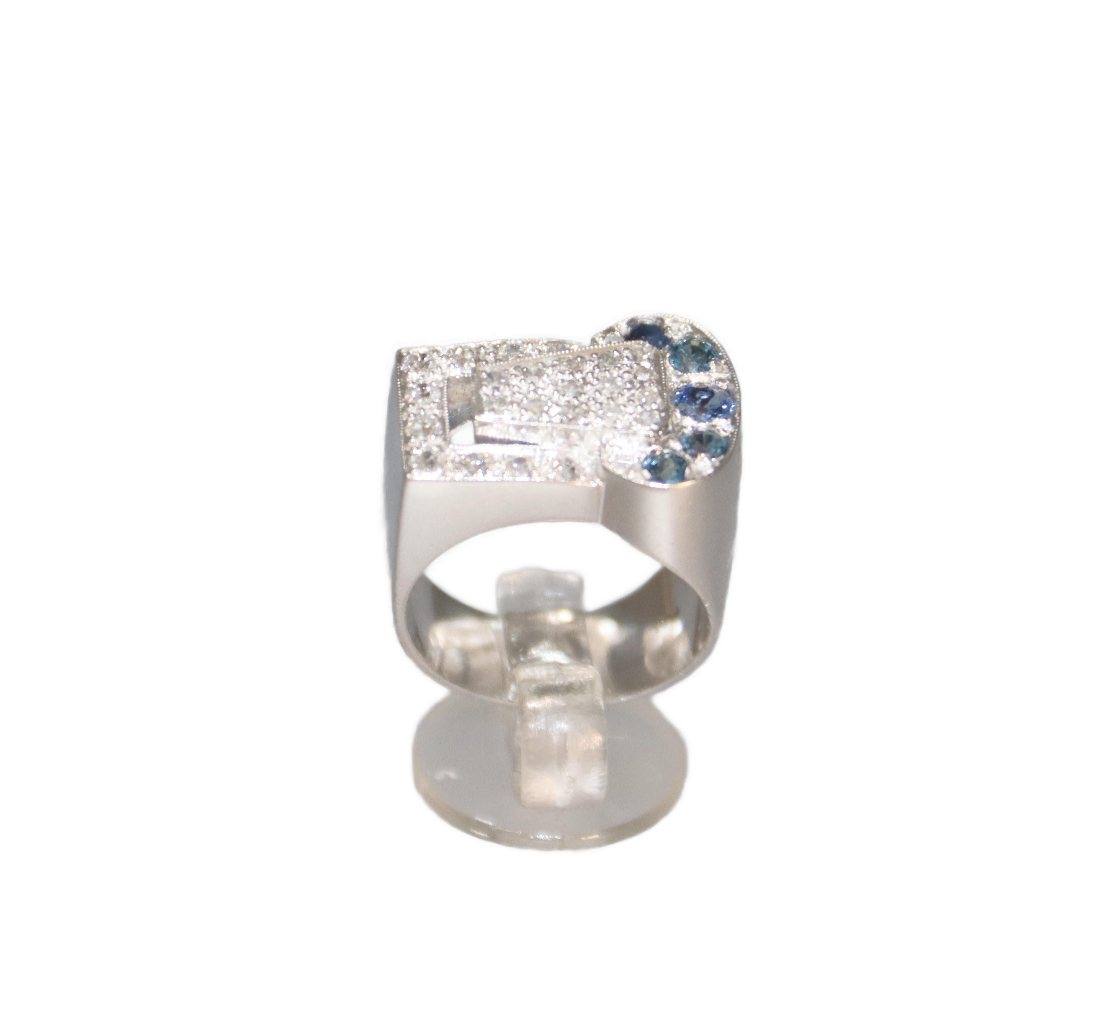 This stunning ring is a masterpiece of elegance and refined craftsmanship, designed to captivate with its harmonious balance of gemstones and luxurious materials. There are round-cut sapphires totaling 0.40 carats, showcasing a rich and alluring