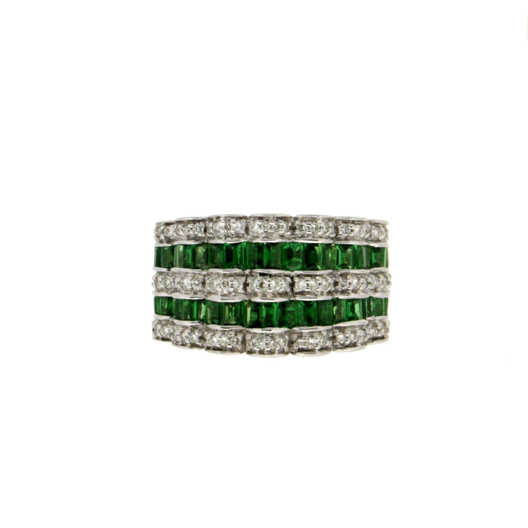 Spectacular 18K white gold band ring is a stunning display of elegance and craftsmanship, featuring wave-like rows of 3 carats of square-cut zavorites, interspersed with equally wave-like rows of 0.60 carats of brilliant-cut diamonds.

The white