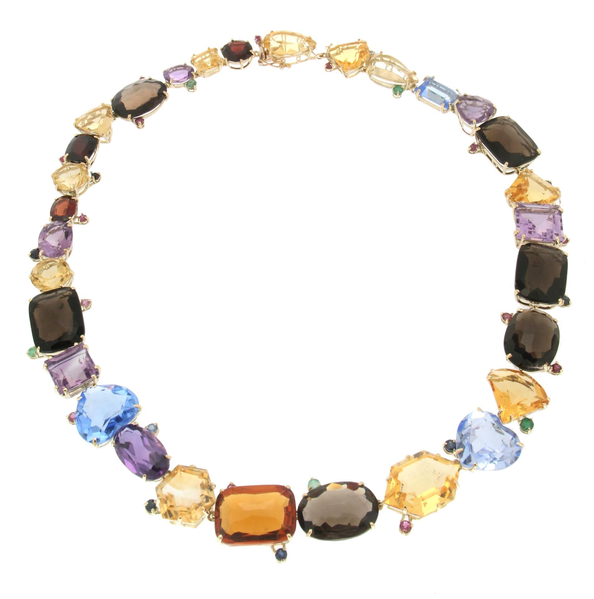 Magnificent necklace made entirely by hand by our expert craftsmen in 14 carat yellow gold, composed of gems of various types of cut. Citrines, amethysts, garnets while small emeralds, sapphires and rubies are the side dish.

The necklace has a