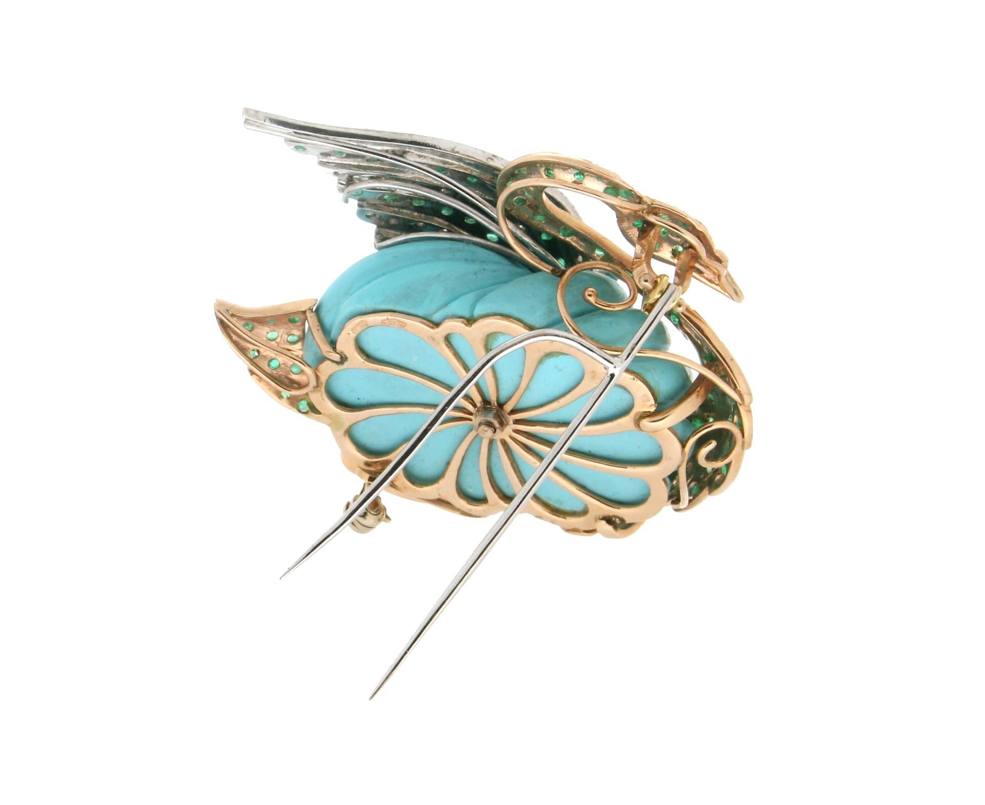 Splendid brooch representing a swan designed and then made entirely by hand by our artisans, made of 14 Carat yellow and white gold. A hand-engraved turquoise paste stone was used for the body, while the wings and the remaining parts of the body are