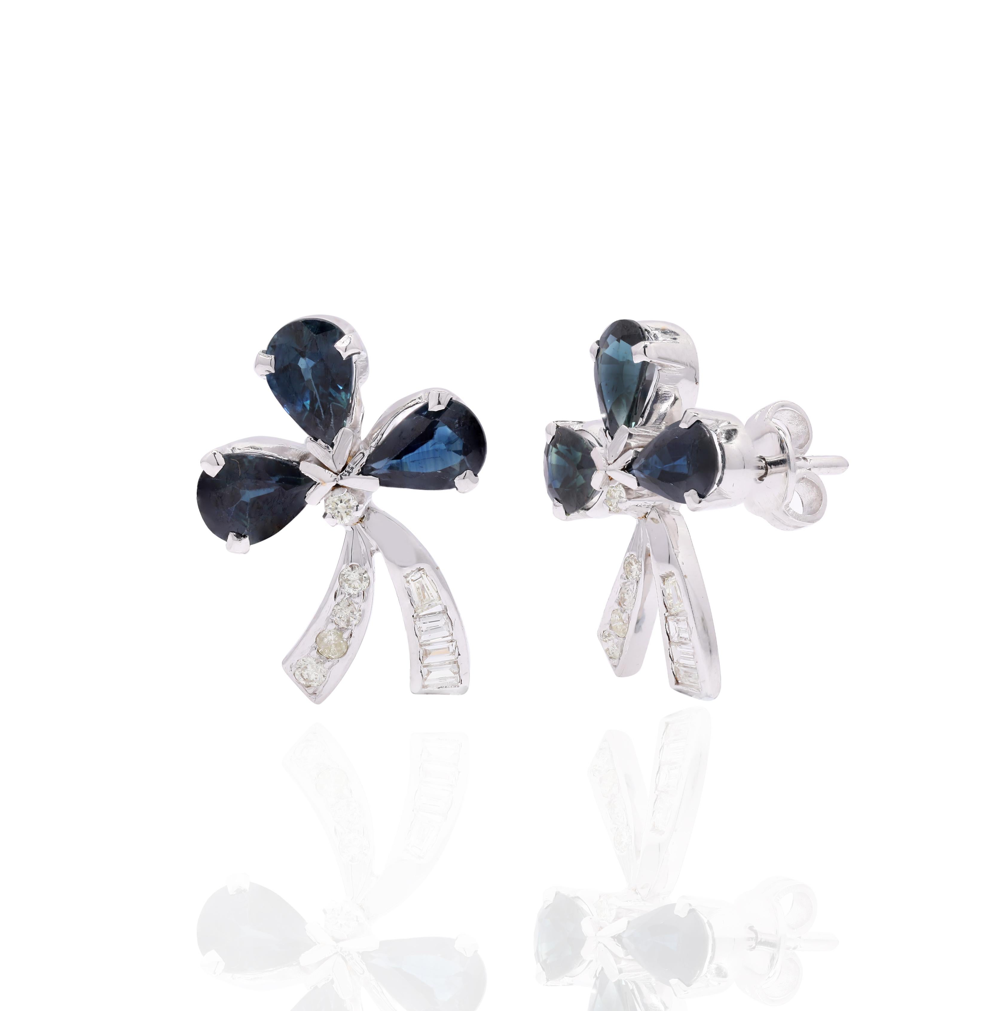 Studs create a subtle beauty while showcasing the colors of the natural precious gemstones and illuminating diamonds making a statement.
Pear cut blue sapphire studs with diamonds in 14K gold. Embrace your look with these stunning pair of earrings