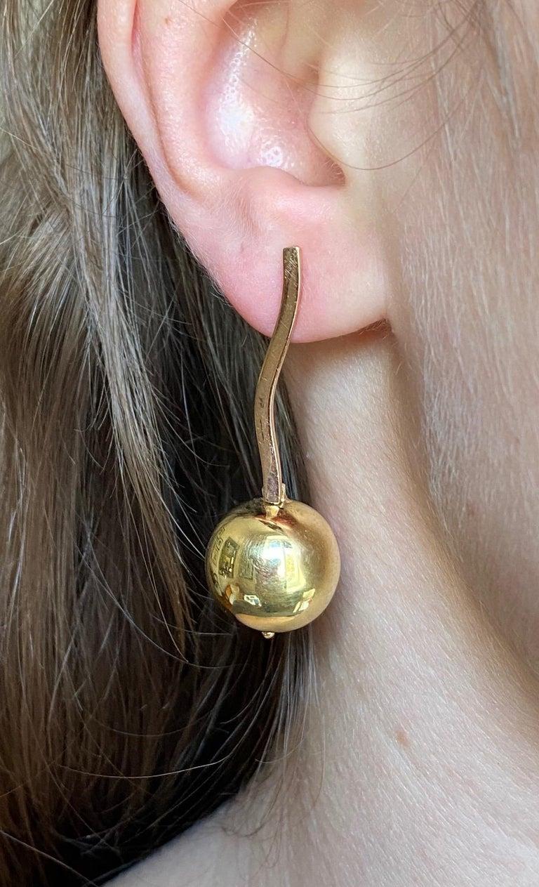 Handcrafted 18 Karat Yellow Gold Sun Globes Dangle Modern Design Earrings
These sun globes earrings are handcrafted in 18 karats yellow gold and they give a nice light to your face while wearing them. 
Sun is such an important element for our lives