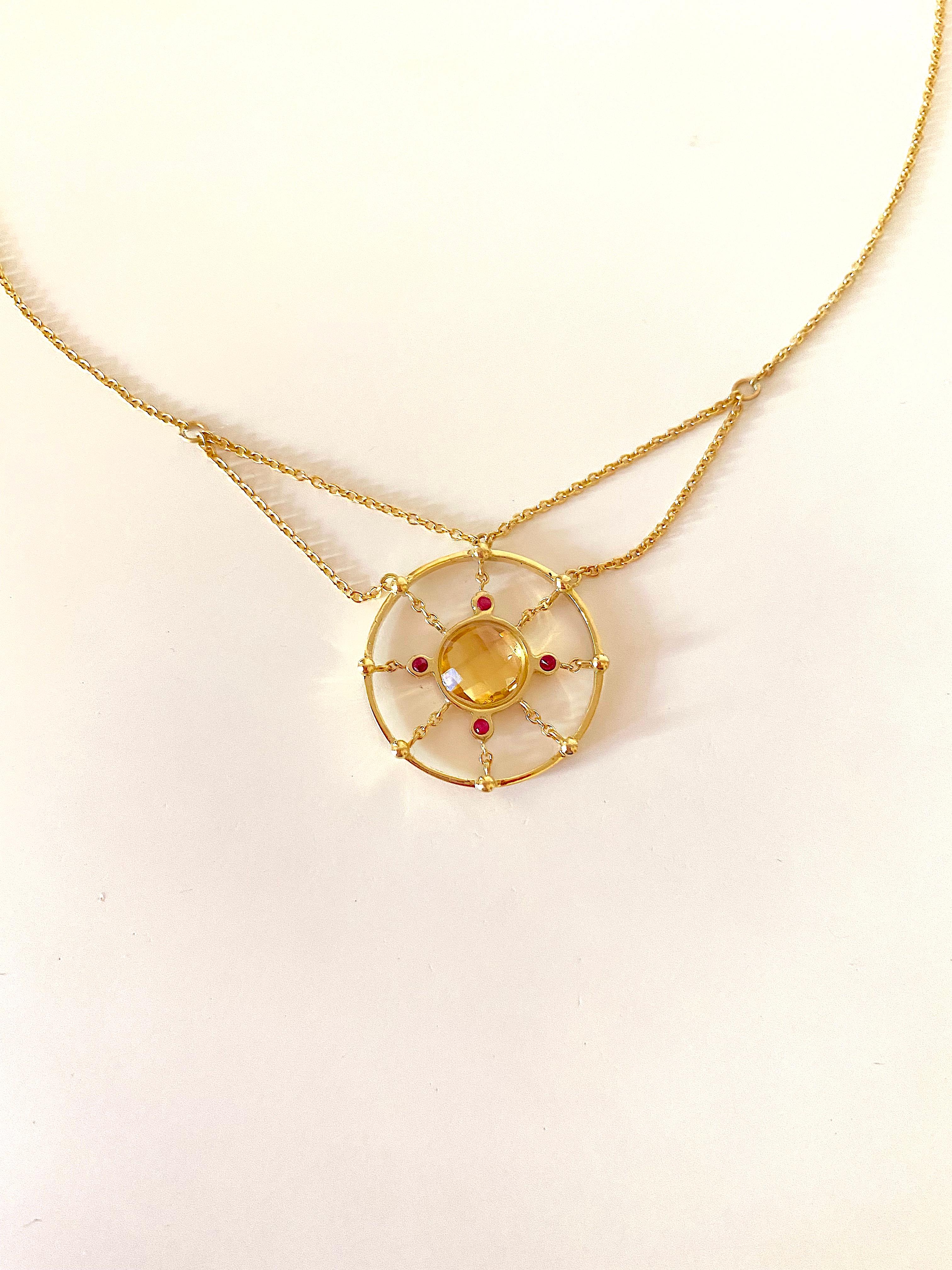 Handcrafted 18 Karats Yellow Gold Citrine Rubies Design Chain Pendant Necklace 
A sunny pendent on a chain necklace handcrafted in 18 karats yellow gold and embellished with a 4 rubies that balance the radiant citrine central stone.
The lenght of