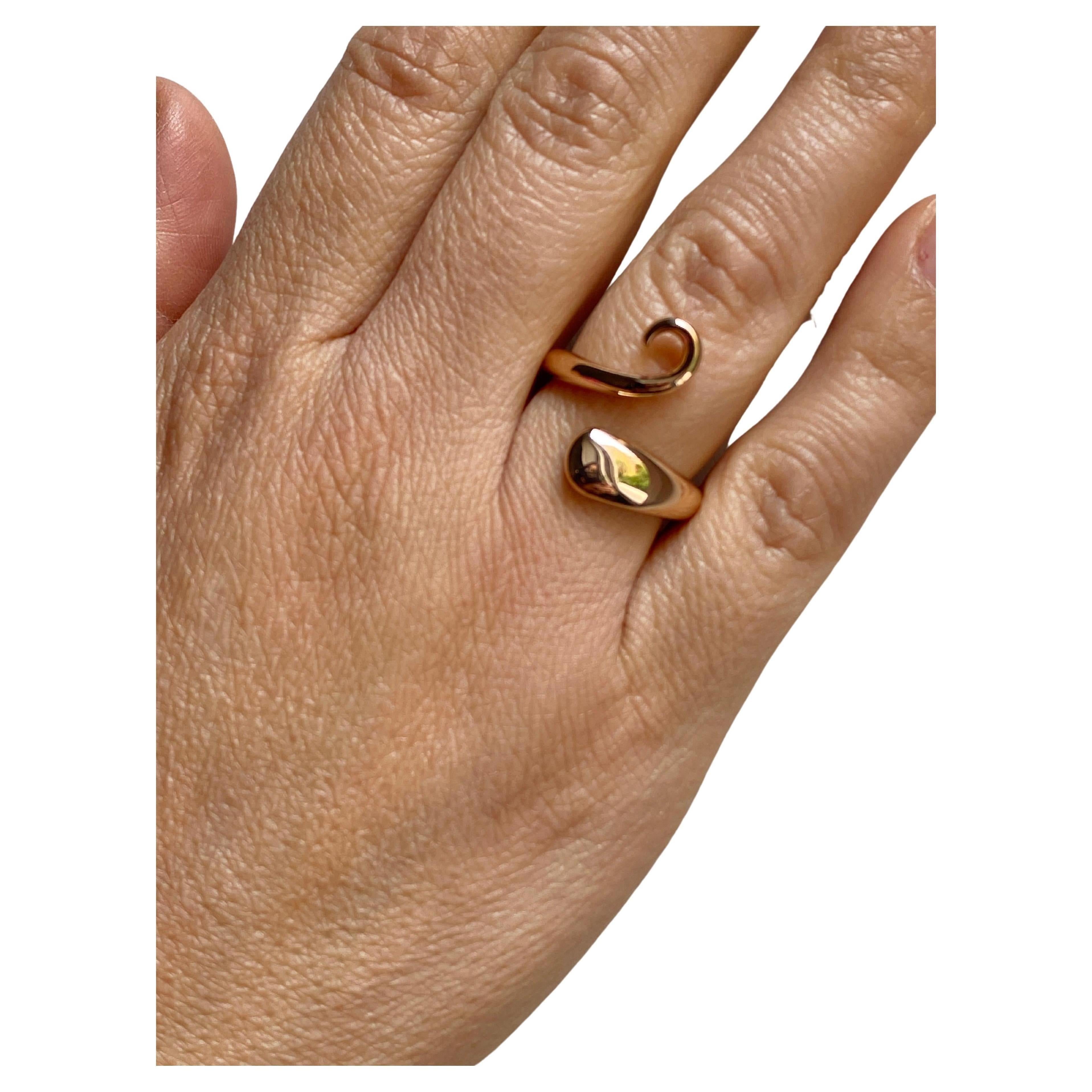 Rossella Ugolini Design Collection. This beautiful surrealist 18k Yellow Gold Ring is Handcrafted in Italy by skilled artisans, making it a unique and one-of-a-kind piece. Inspired by the graceful curve of a cat's tail, the ring features a twist in