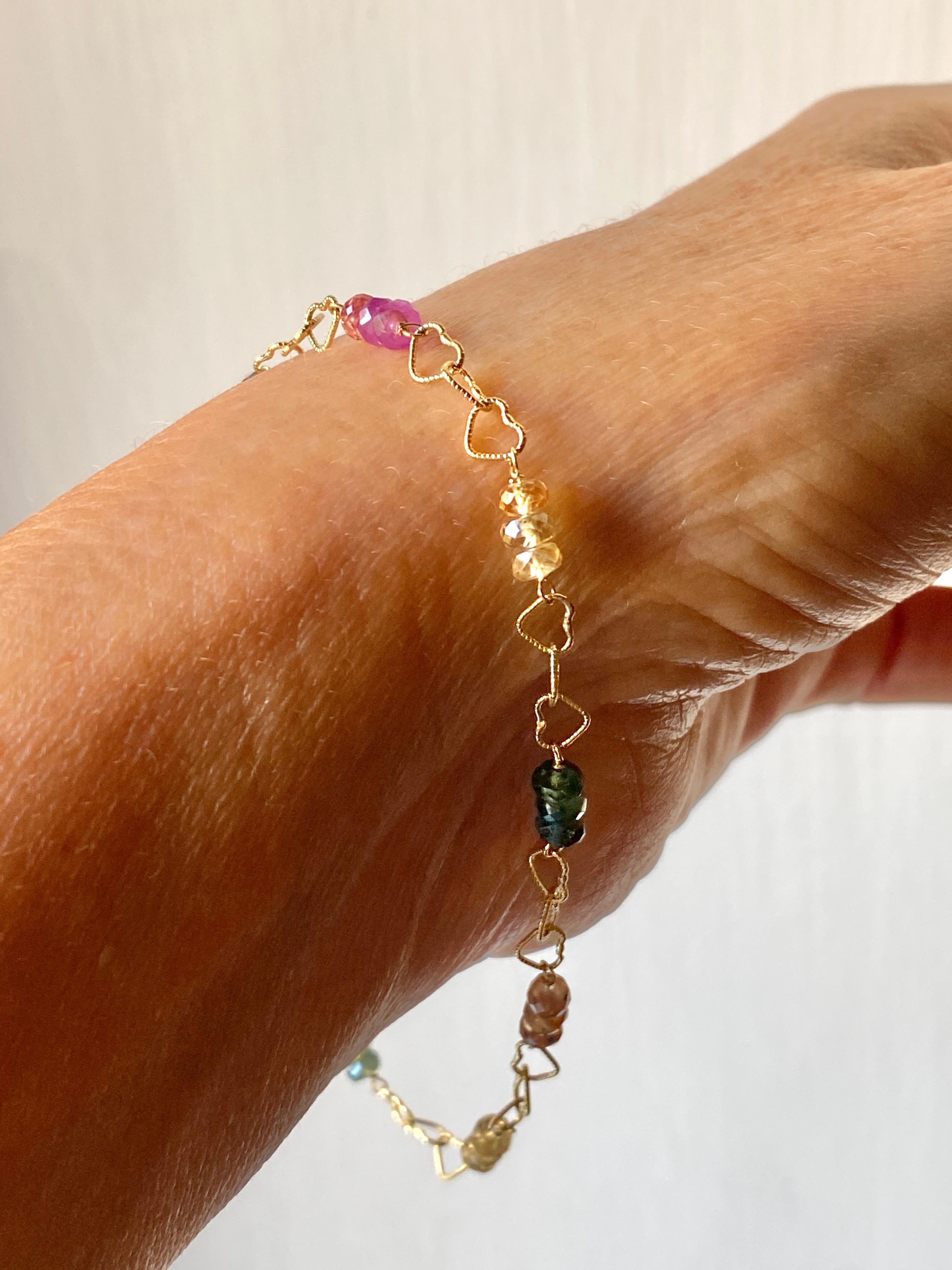 Rossella Ugolini Design Collection Exquisite 18K Yellow Gold Multicolor Sapphires Beads and Slightly Hammered Hearts Chain, Handcrafted in Italy. This enchanting bracelet features a colored array of Sapphires, forming a beautiful rainbow effect