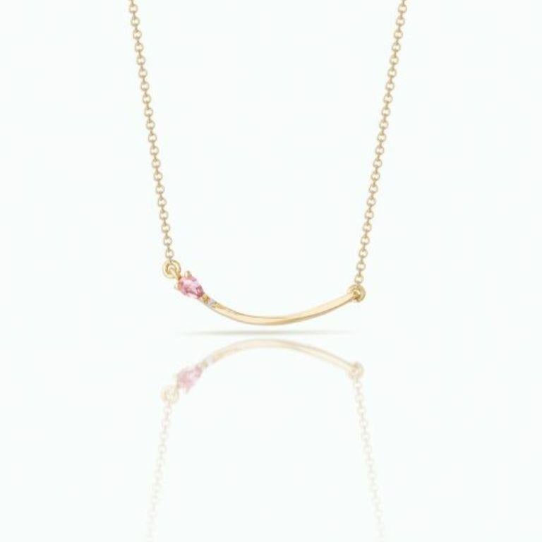 A necklace with a graceful flow of line, this stunning piece is handcrafted in 18 Carat Yellow Gold and features a beautiful pink pear-shaped sapphire, complemented by pave-set brilliant cut diamonds. Perfect for those who appreciate subtle yet