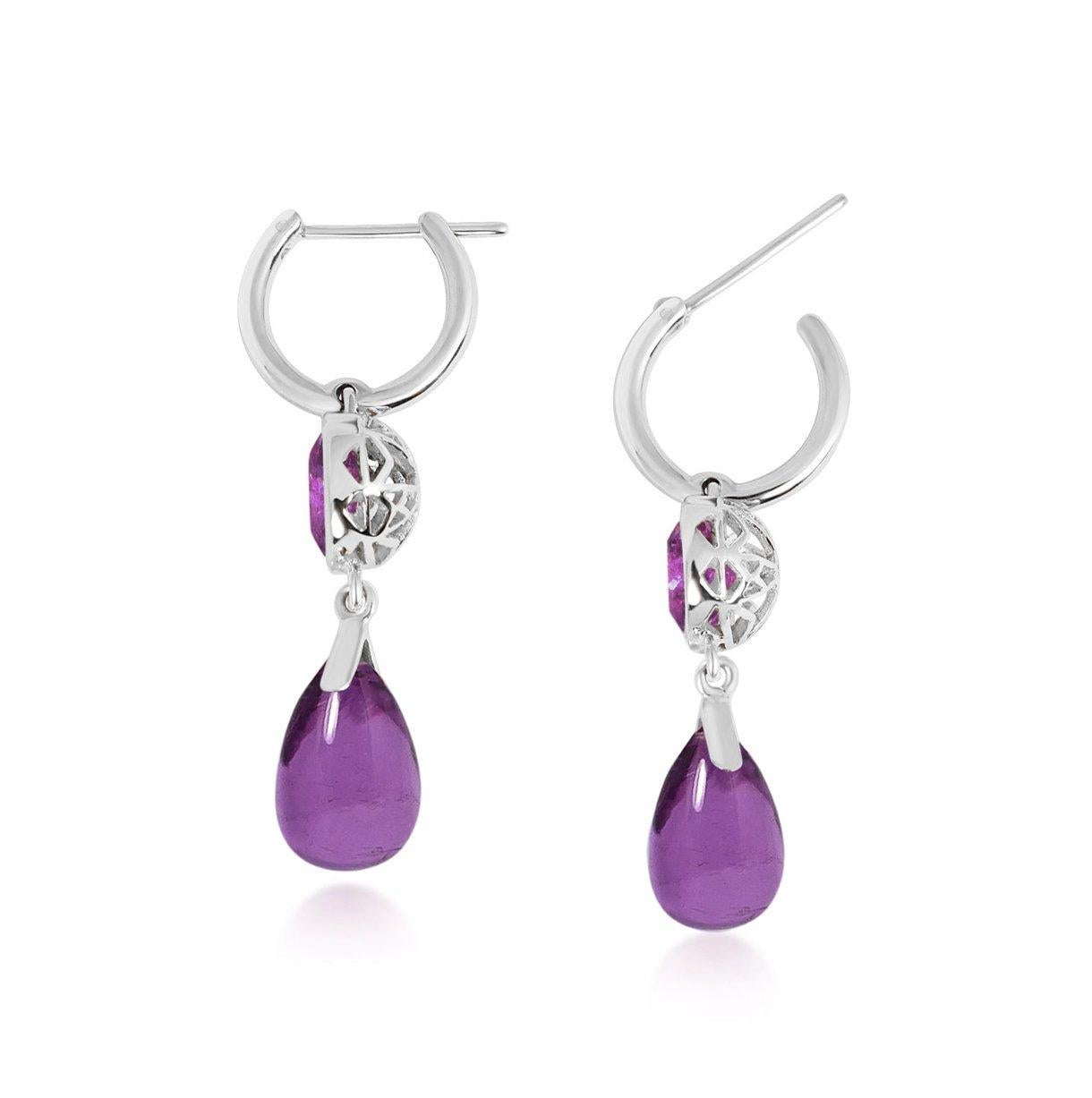 Handcrafted 2.40 & 6.20 Carats Amethysts 18 Karat White Gold Drop Earrings. Dancing drops carved in Amethyst under a set of 8mm round cut Amethyst stones encased in our iconic hand pierced gold lace to let the light through. A diamond has been set