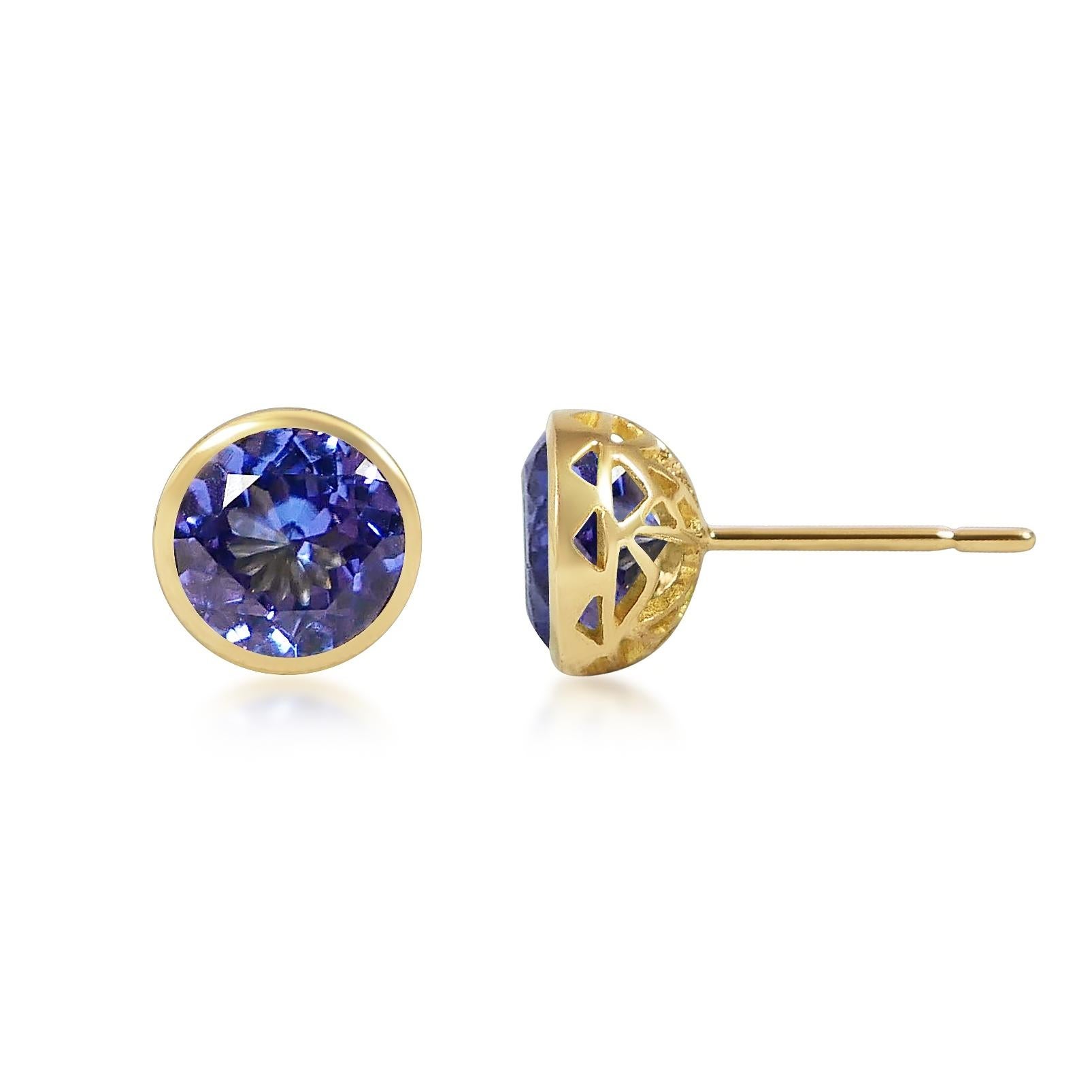 Handcrafted 2.80 Carats Tanzanite 18 Karat Yellow Gold Stud Earrings. The 8mm natural stones are set in our iconic hand pierced gold lace to let the light through our precious and fine stones our earrings are the perfect everyday wear.

Named after