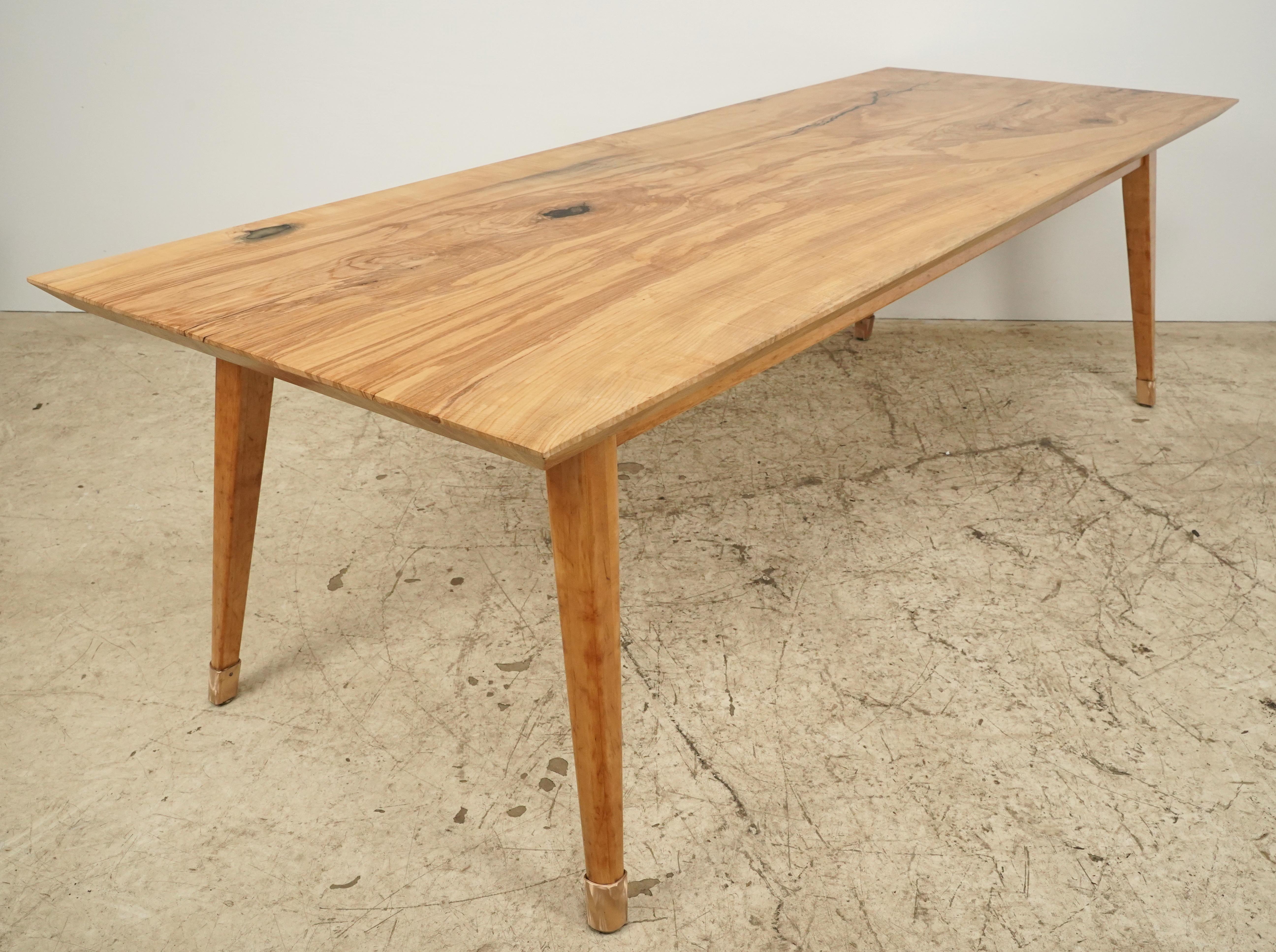 The top is made from one slab of ash filled in with epoxy. The tabletop has a bottom bevel. The base is reclaimed and made by Standard Wood Products Corporation, Library Division. This piece was handcrafted in our table shop in Scranton, PA. and is