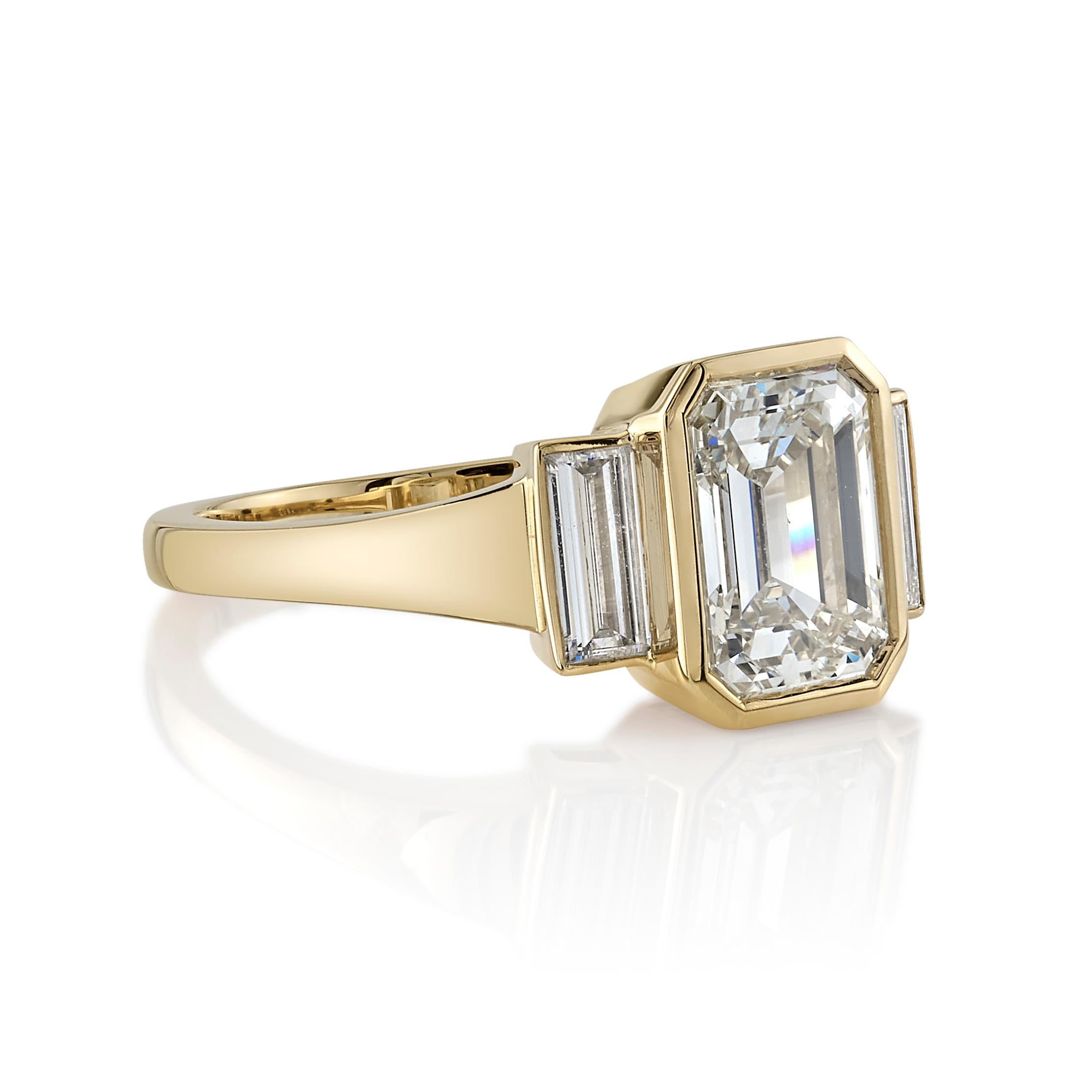 2.00ct N/VVS2 GIA certified emerald cut diamond with 0.35ctw French cut accent diamonds bezel set in a handcrafted 18K yellow gold mounting.