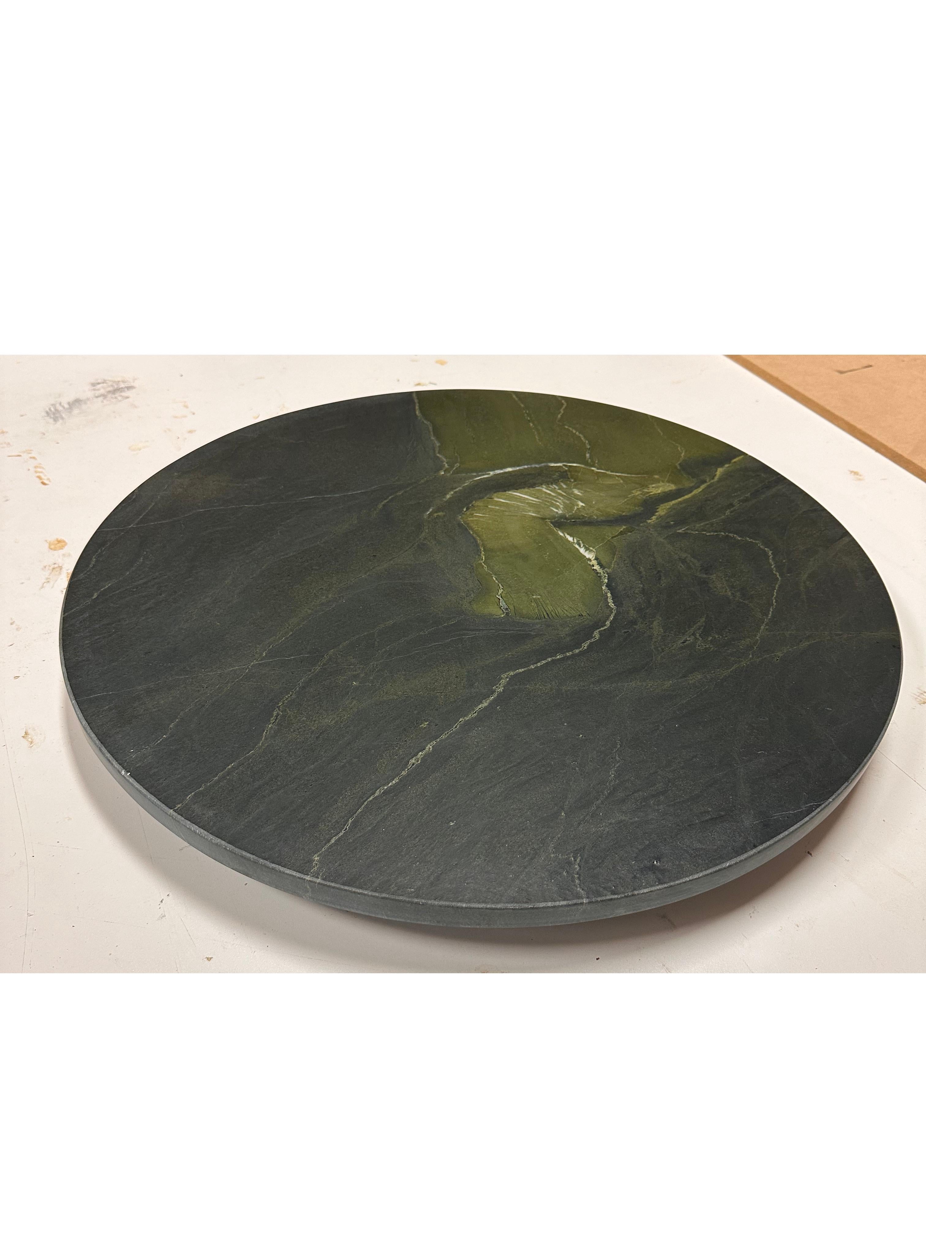 Designed to be the perfect, round functional accent to any table, our Lazy Susan is available as a solid wood or marble-topped piece. The image shown is fabricated in a dramatic Avocatus Quartzite Top with a leathered finish and a  blackened oak