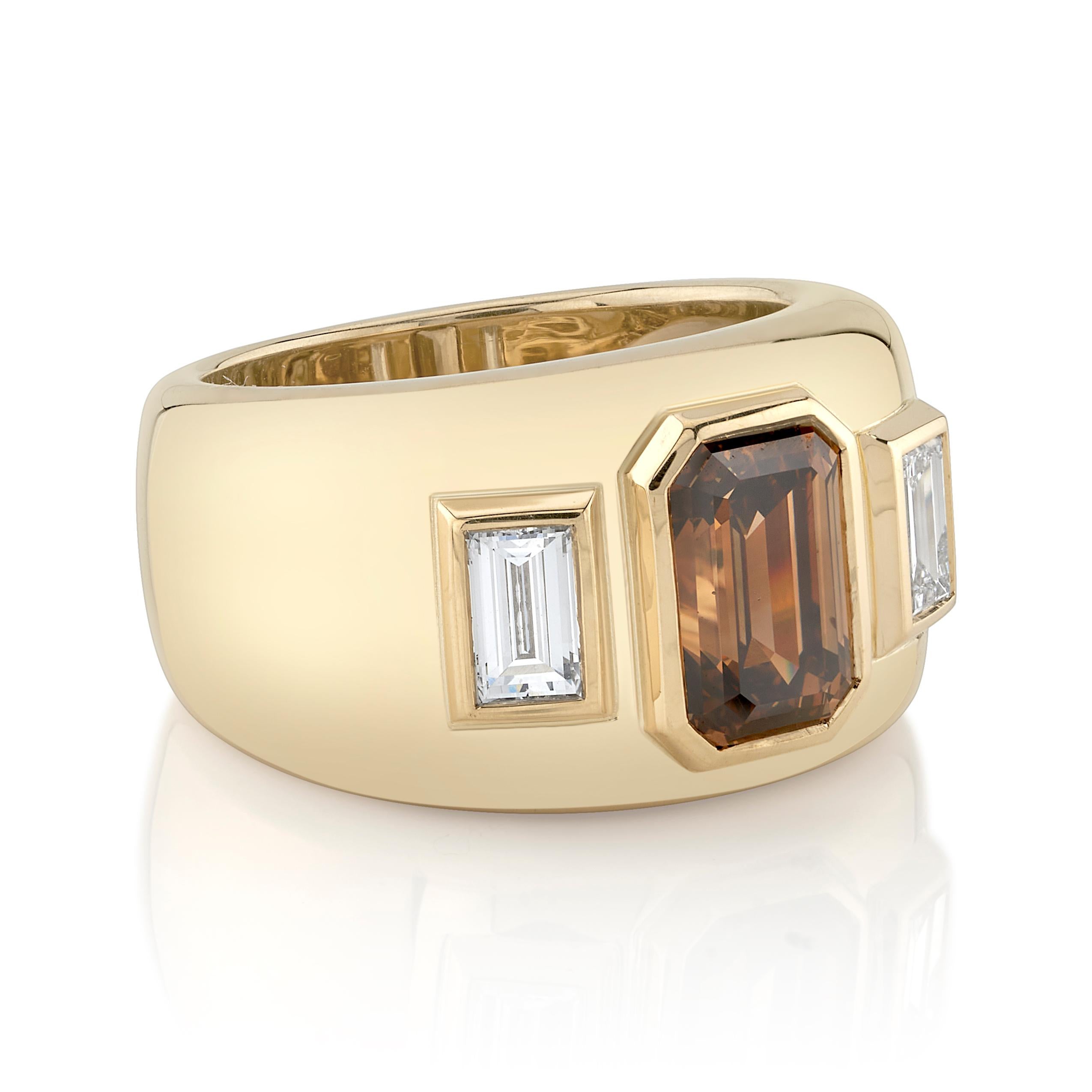 2.34ct Fancy Dark Orange Brown/SI2 GIA certified emerald cut diamond with 0.62ctw baguette cut accent diamonds set in a handcrafted 18K yellow gold mounting.

