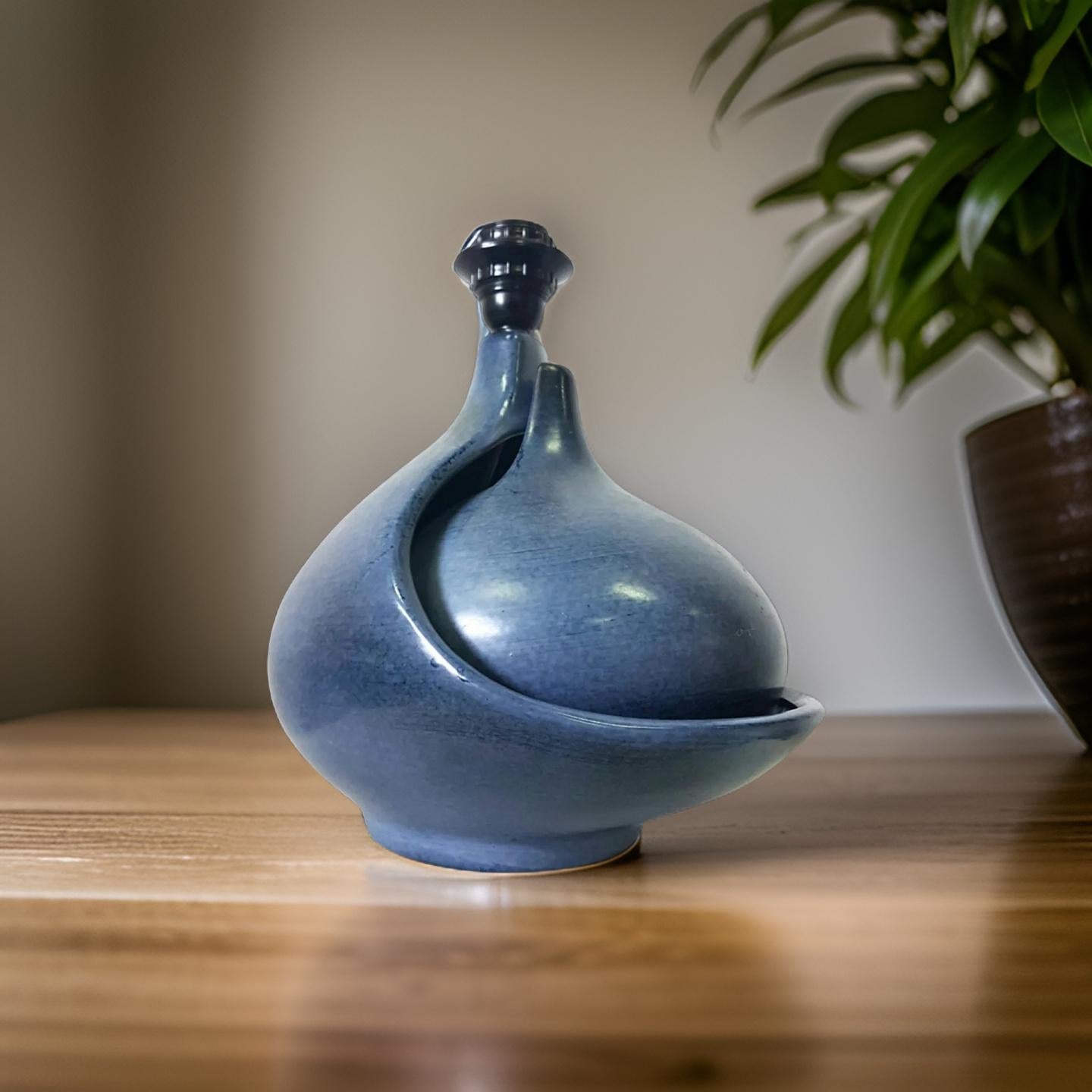 Handcrafted table lamp by Fred and Andree Stocker. Made from ceramics with a blue glaze finish. The inner part fits inside the main piece. We are not exactly sure what the creators intention was for this or that is is mainly esthetic. You could use