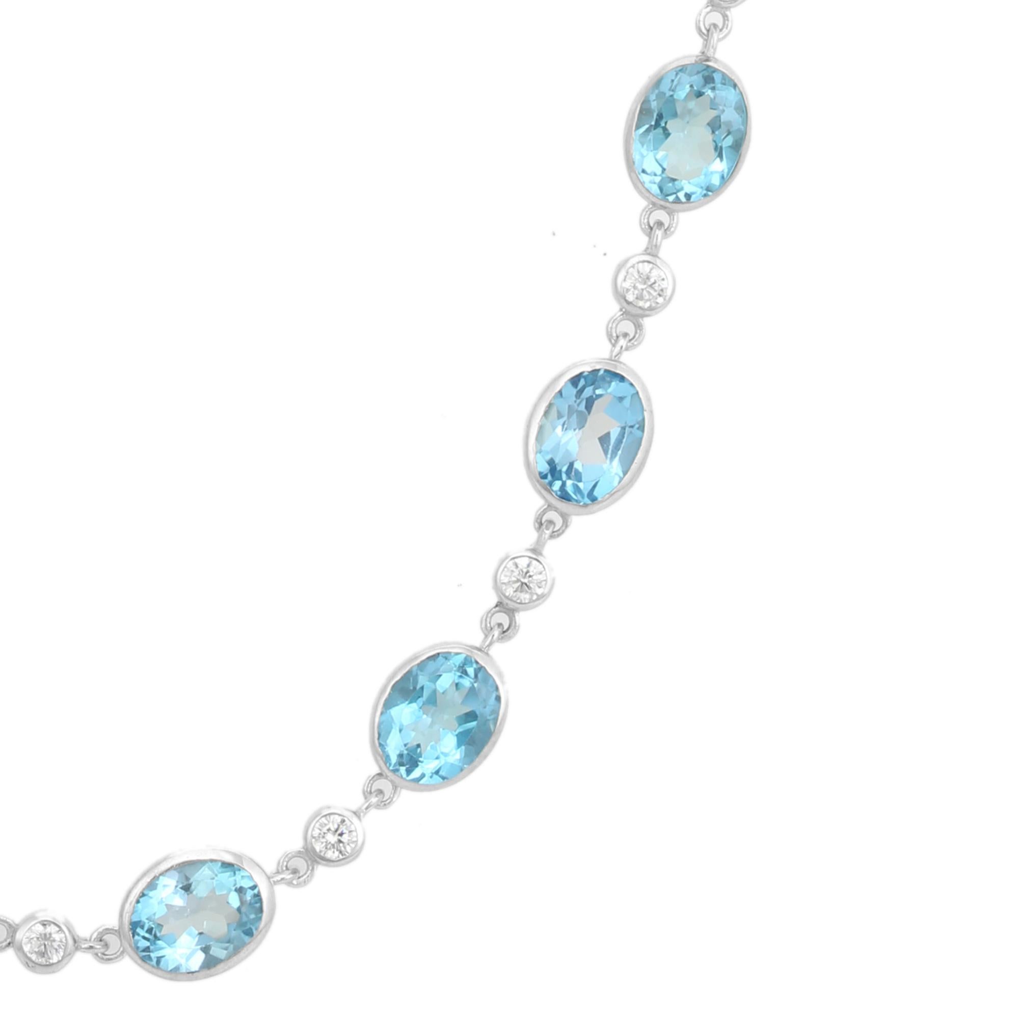 This Handcrafted Blue Topaz and Zircon Stone Station Necklace exquisite station necklace, crafted in fine 925 sterling silver. Featuring a series of vivid oval-cut blue topaz gemstones, each bezel-set for a sleek and polished look, the necklace is
