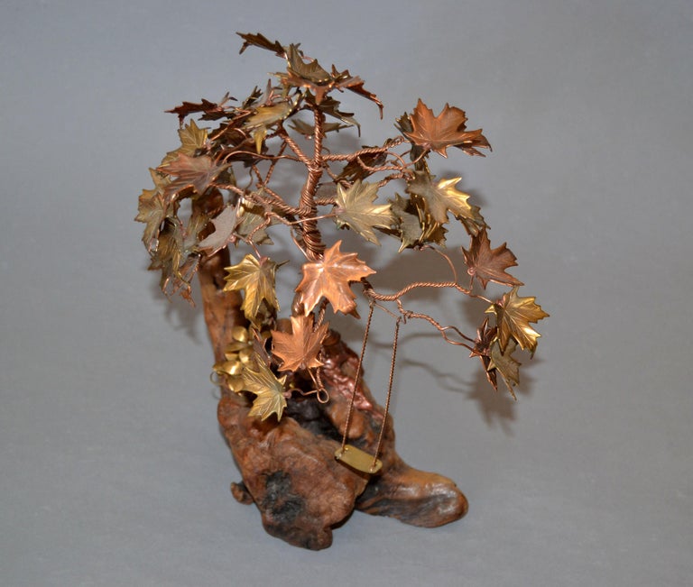 Whimsical Organic Modern handcrafted Bonsai Tree Sculpture in Brass, Copper, Bronze on a Burl Wood Base.
Note the details of the leaves and the swing.
No signature found.