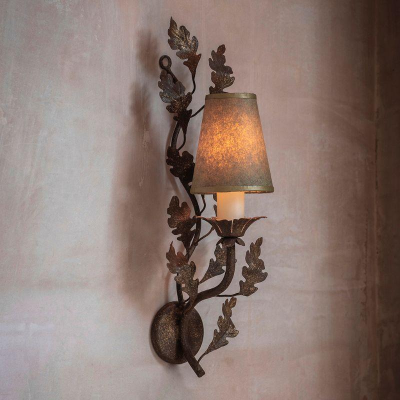 Handcrafted in wrought iron, Beaumont & Fletcher's lovely little Woodbury wall sconce features delicate hand cut oak leaves radiating from a single stem. Each piece is brought to life through exceptional craftsmanship and incredible attention to