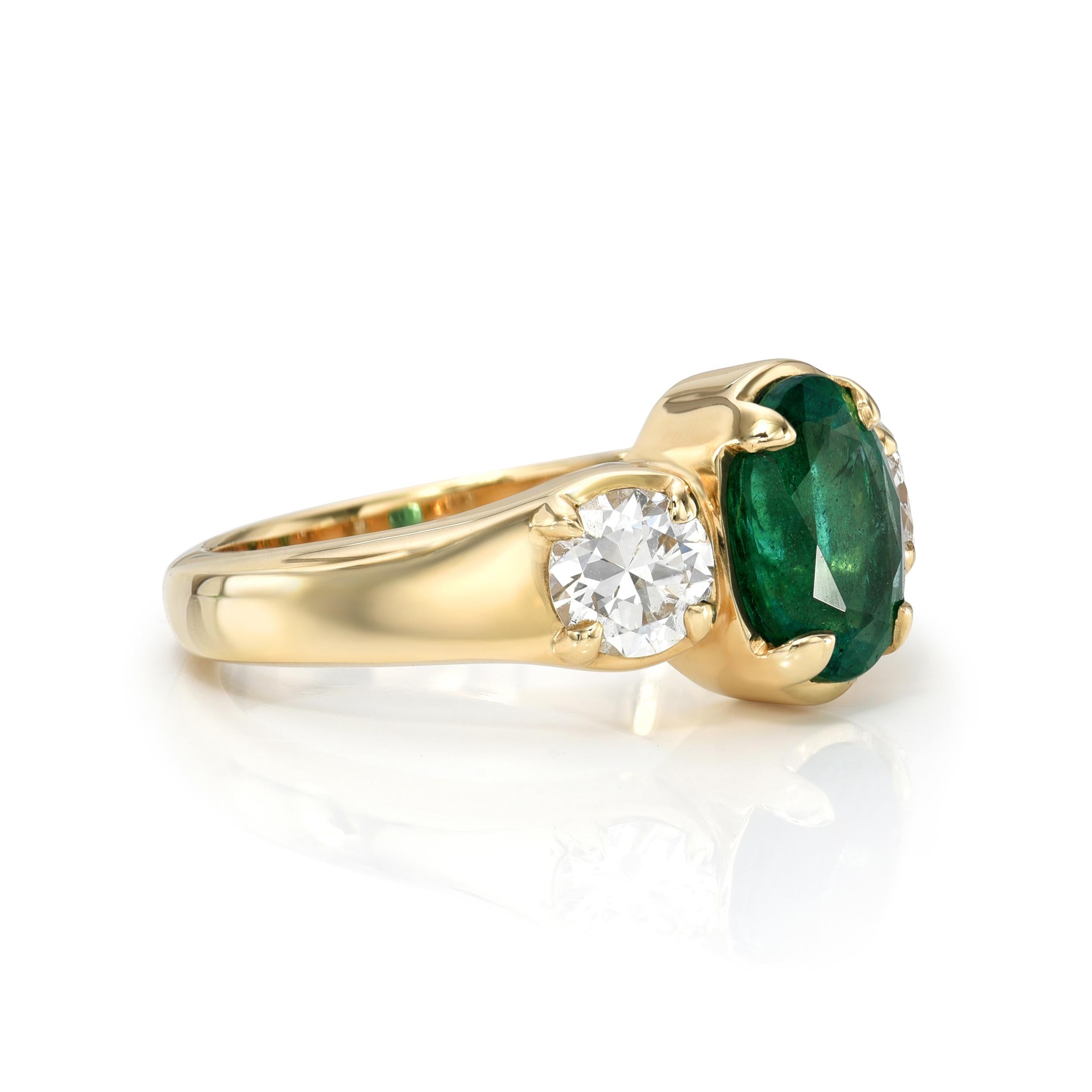 2.05ct GIA certified Zambian cushion cut green emerald with 0.94ctw I-K/SI1-SI2 GIA certified old European cut accent diamonds prong set in a handcrafted 18K yellow gold mounting.