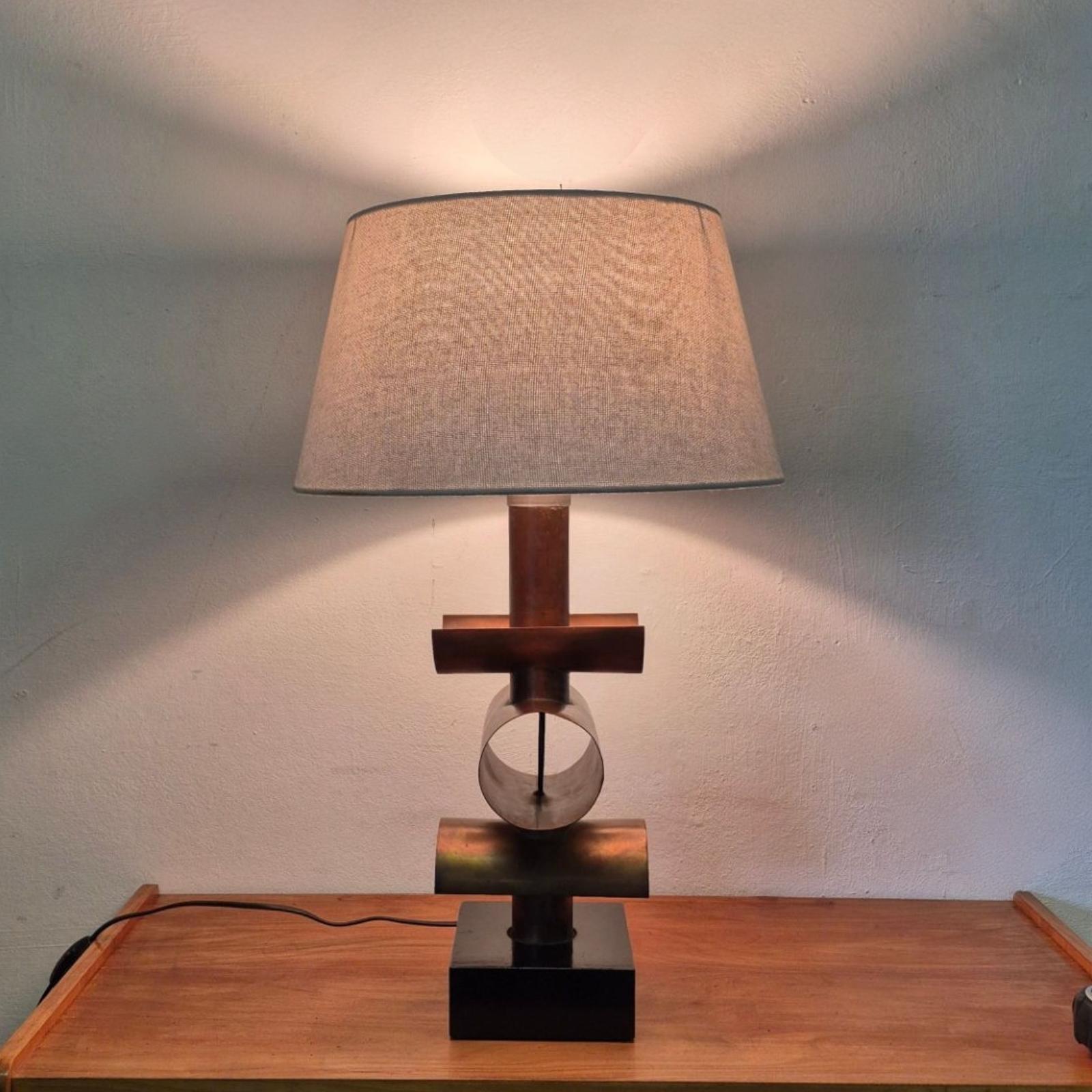 Brutalist mid century table lamp. Handcrafted from copper pipes and set on a black lacquered base. 

