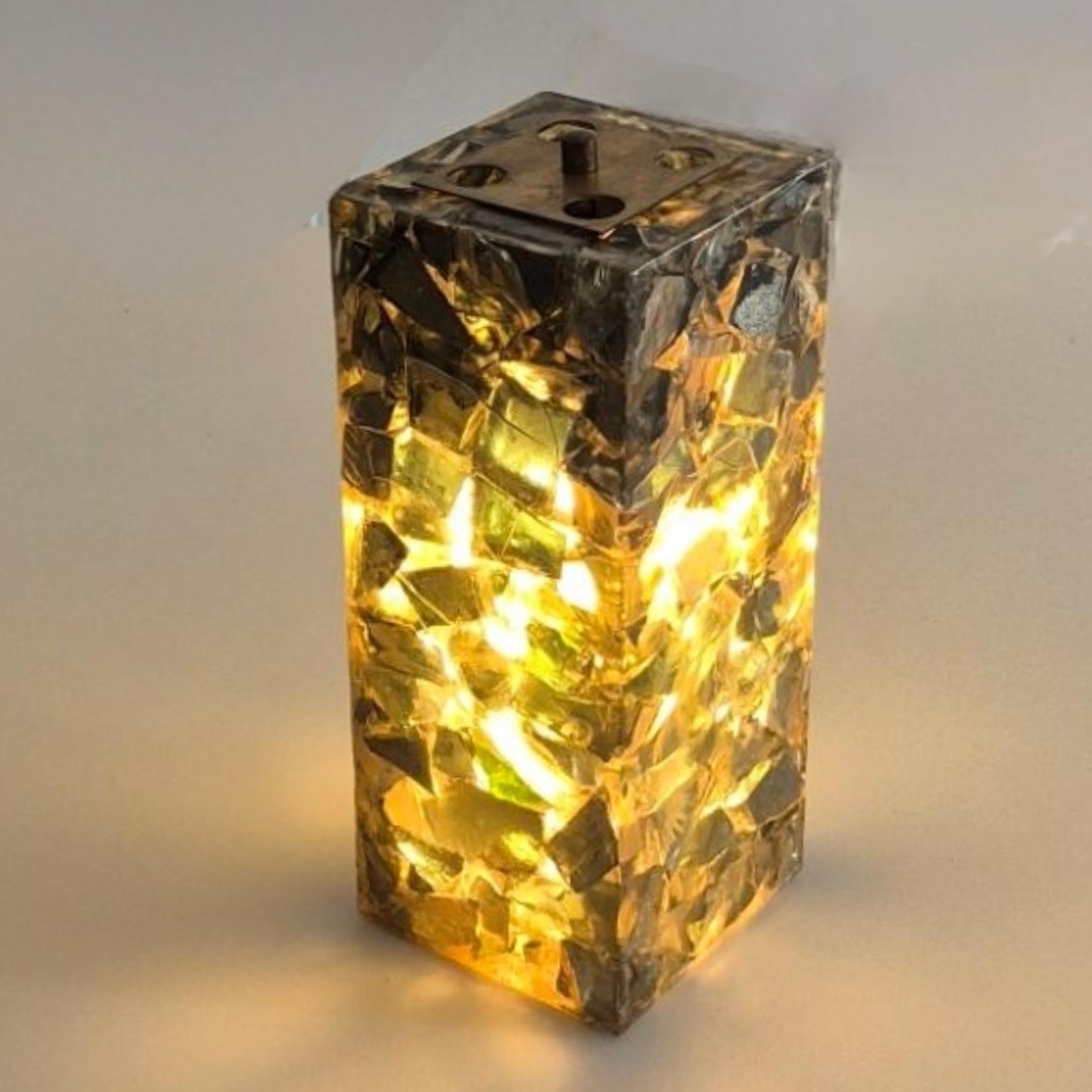 Colorful handcrafted table lamp. Made from pieces of colored glass cast in resin. 
The pieces of glass disperse the light in a unique way. Colorful and unique piece that will light up every interior. 

